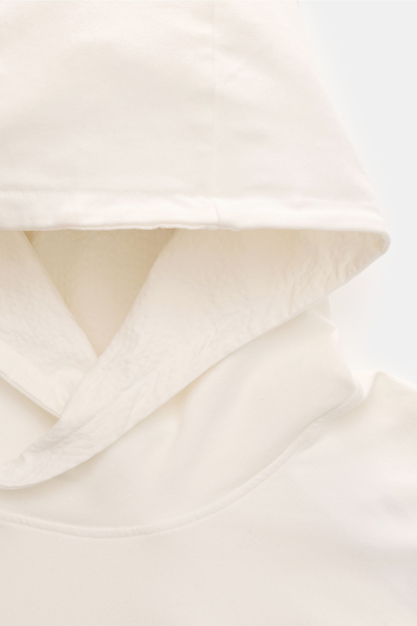 Close-up front view of the hood and upper chest of the 04651/ A trip in a bag Kapuzenpullover 'IF Hoodie' offwhite, made of brushed elastic cotton jersey with a very soft feel, featuring a regular fit, practical hood, small side seam web label, and comfor
