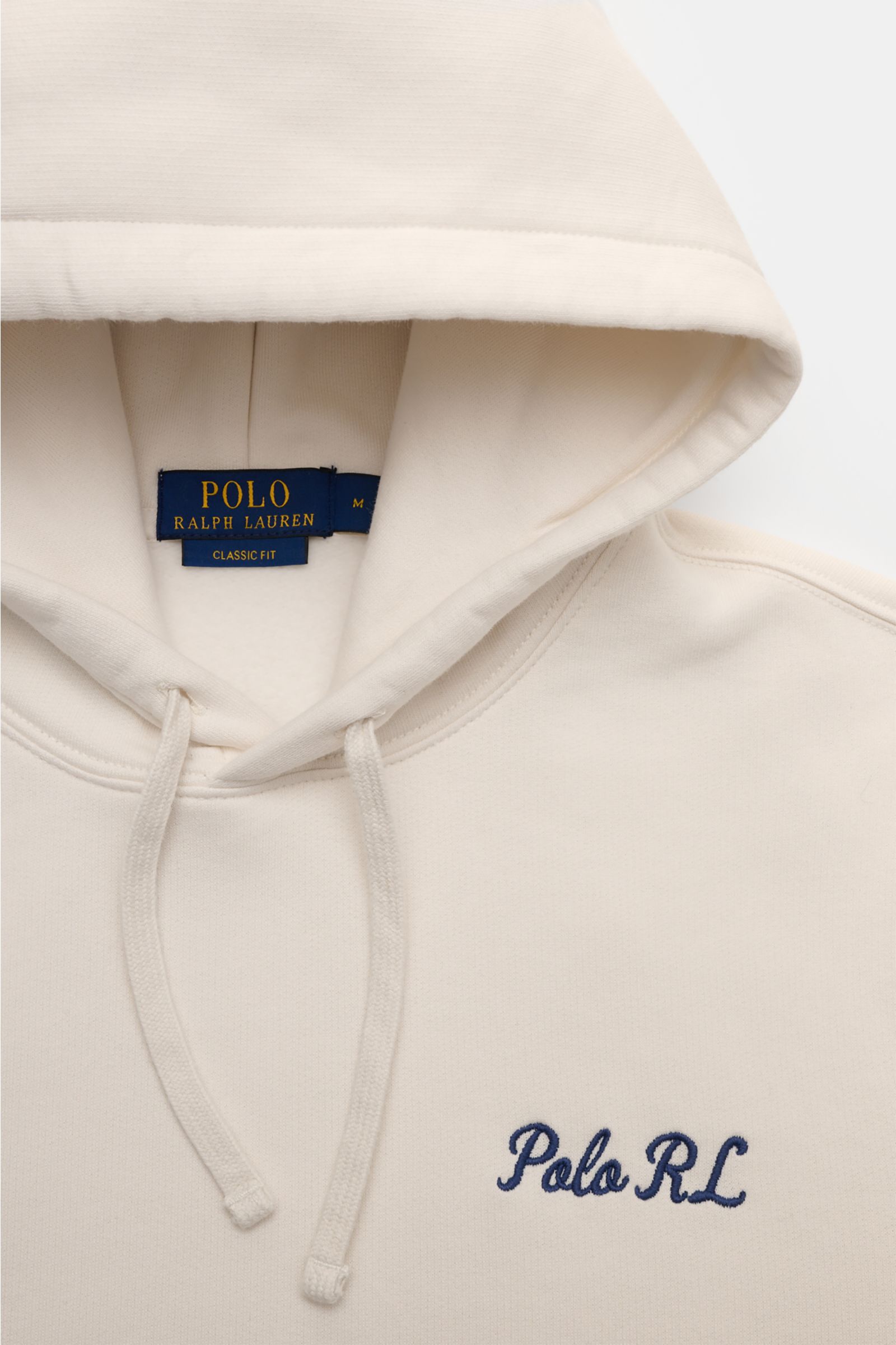 Close-up front view of Polo Ralph Lauren Hooded jumper white showing drawstring hood, navy 'Polo RL' embroidery on chest, and soft fleece inside.

Iconic signature style by POLO RALPH LAUREN: This hooded jumper with a soft fleece lining combines casual