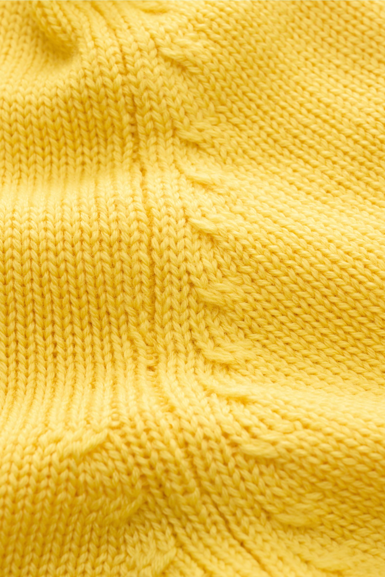 Close-up front view of B.F. Knitwear Merino turtleneck jumper yellow showing pure merino wool, soft feel, fully fashioned, semi chunky knit, slim fit, ribbed turtleneck, and flexible ribbed bands.