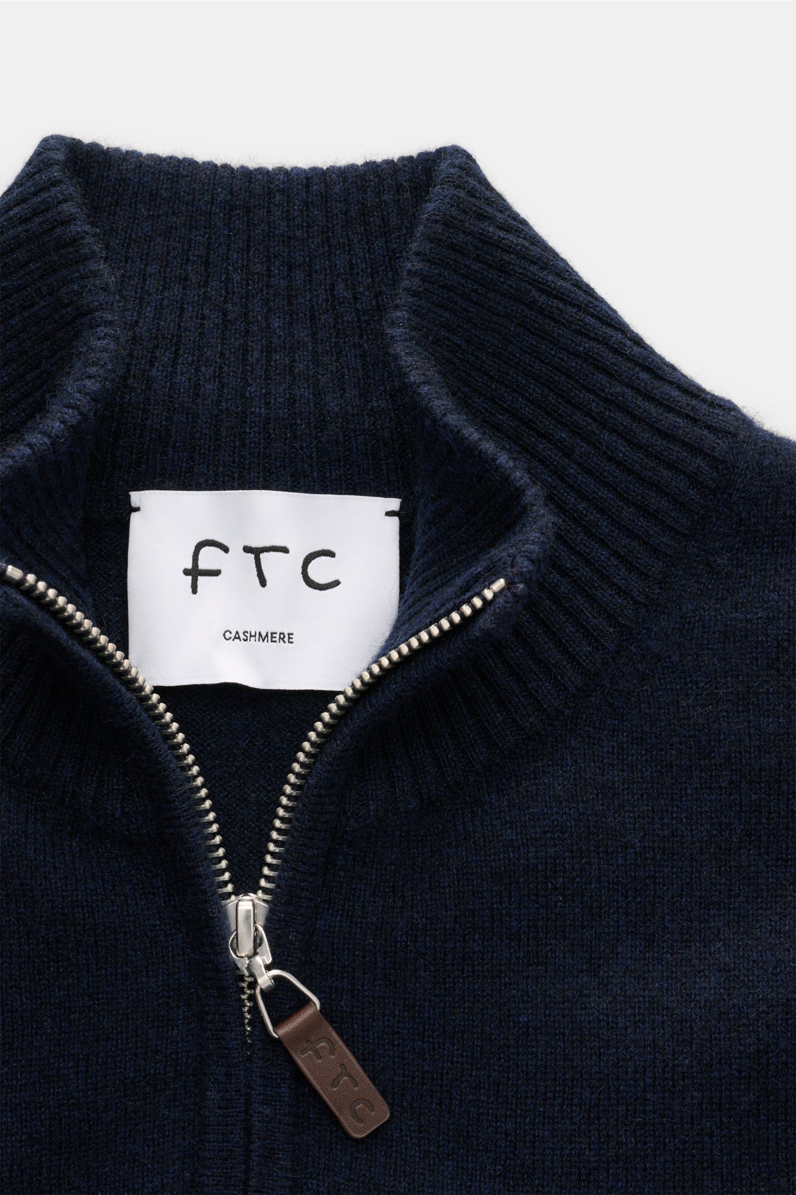 Close-up front view of the FTC Cashmere half-zip jumper navy, showing the half-zip collar with silver zipper and leather pull, ribbed bands, and fine knit texture. Luxurious comfort: This soft half-zip jumper by FTC has a timeless design that makes it a v