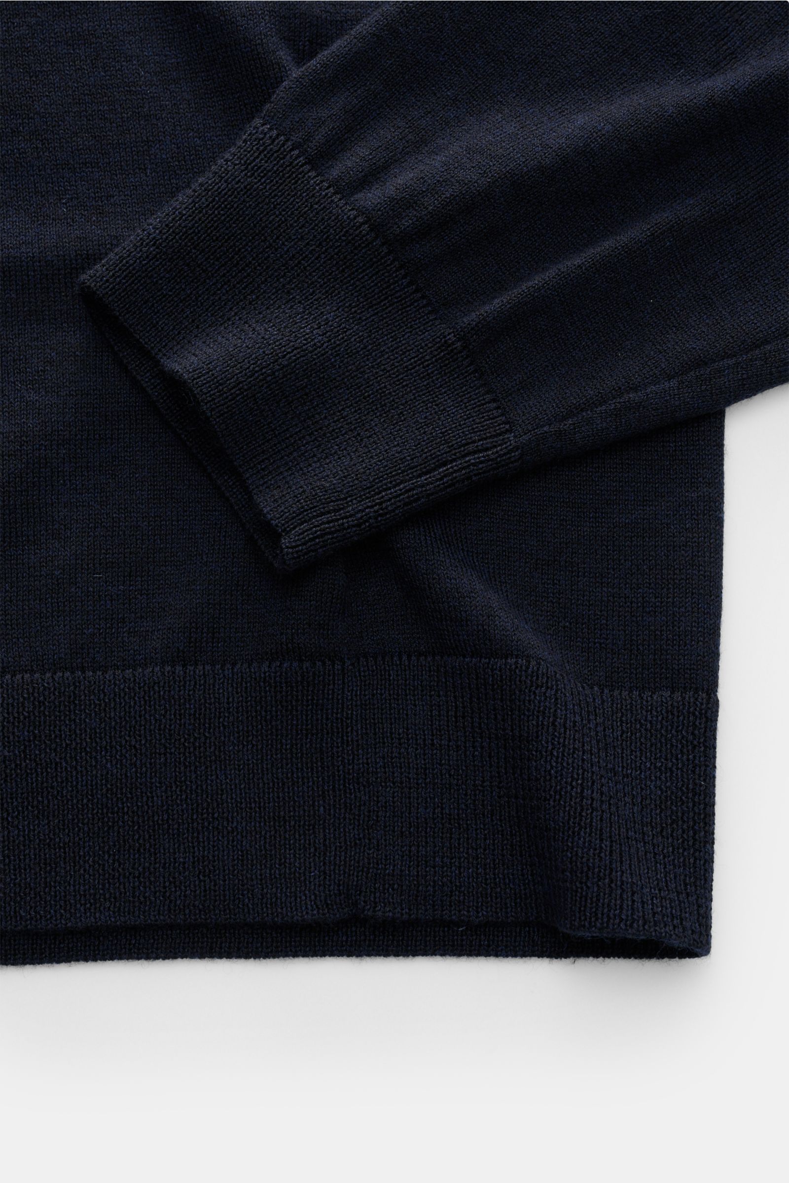 Close-up image of the cuff and hem of the FTC Fine knit-turtleneck jumper navy, photographed from above, showing its very fine knit and ribbed bands. Innovative luxury: This turtleneck jumper by FTC combines fine cashmere with innovative SeaCell – a lyoce