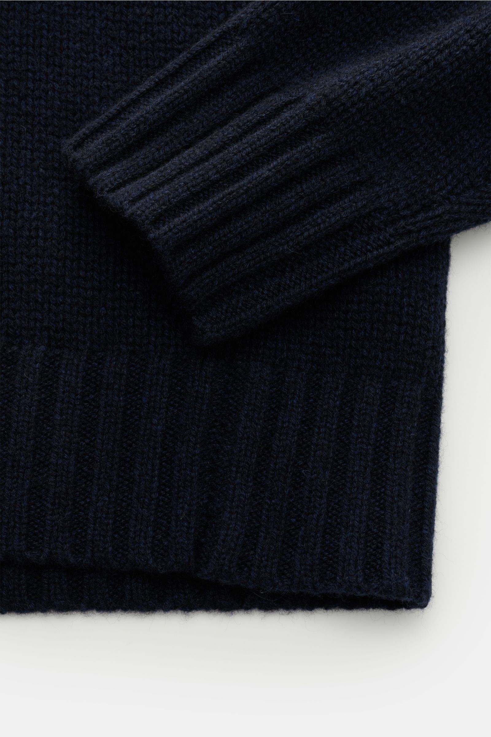 Close-up front view of the navy FTC Cashmere turtleneck jumper showing ribbed cuff and hem in soft, pure cashmere.

The comfort of high-quality, sustainable cashmere makes this timeless turtleneck jumper from innovative knitwear label FTC CASHMERE a fa