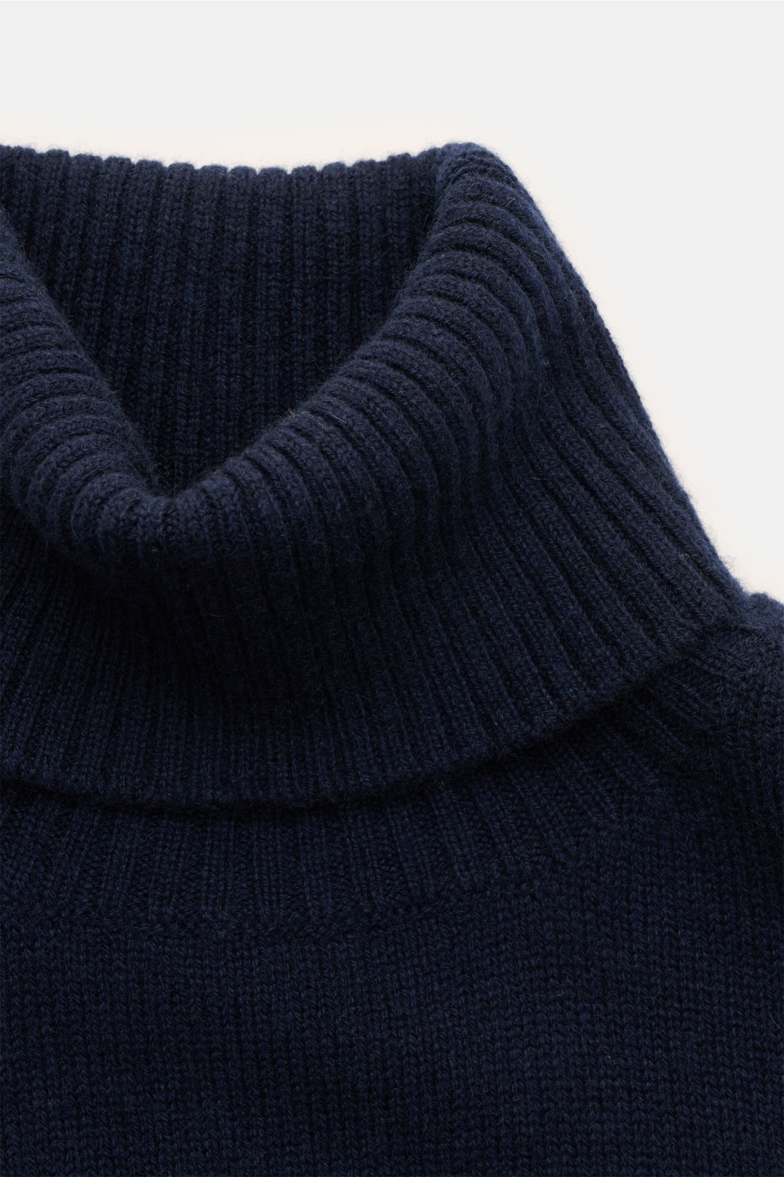 Close-up front view of the navy 04651/ A trip in a bag Cashmere Rollkragenpullover with a ribbed turtleneck, soft 100% cashmere knit, and fine ribbed cuffs.

Zeitloser Komfort für die kalte Saison: Der Rollkragenpullover 'Extreme Cashmere Turtle' von 0