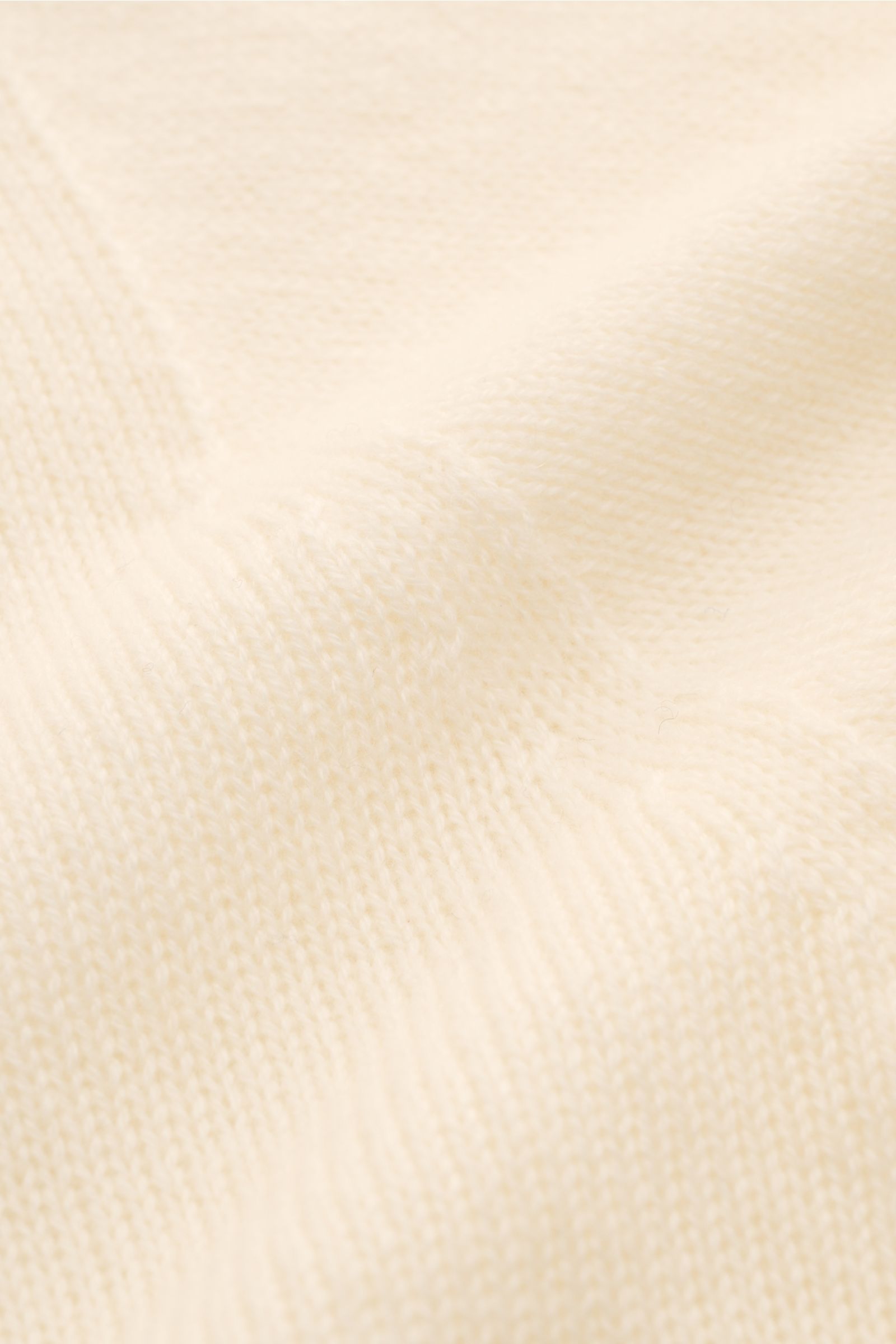 Nahaufnahme des cremefarbenen 04651/ A trip in a bag Cashmere Rollkragenpullovers mit feinem Strickbild, weichem Griff und Rippstrick-Rollkragen.