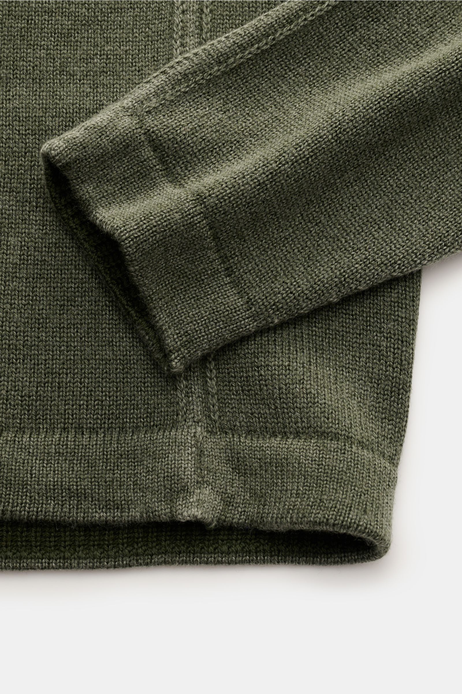 Close-up view of the cuff and hem of the 04651/ A trip in a bag Reversible crew neck jumper 'Foggy Crew' dark green, showing its medium-fine knit and ribbed bands.

Description: 
This reversible jumper 'Foggy Crew' made of pure virgin wool by 04651/ A 
