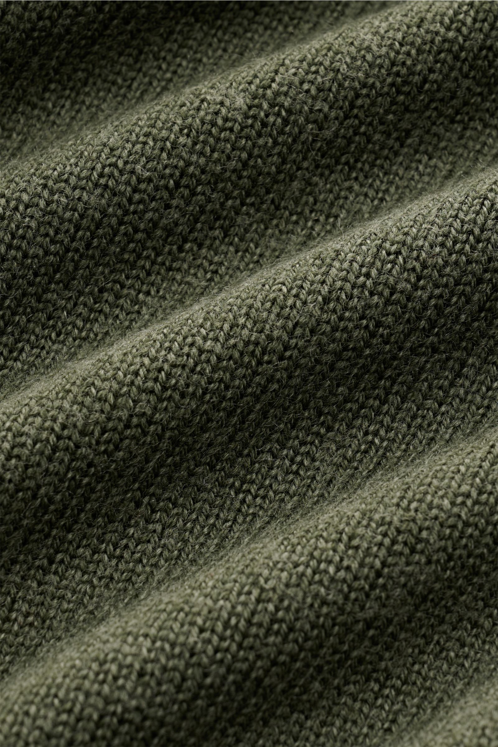 Close-up view of the textured knit fabric in dark green of the 04651/ A trip in a bag Reversible crew neck jumper 'Foggy Crew' showing its medium-fine knit and fuzzy look.

This reversible jumper 'Foggy Crew' made of pure virgin wool by 04651/ A TRIP I