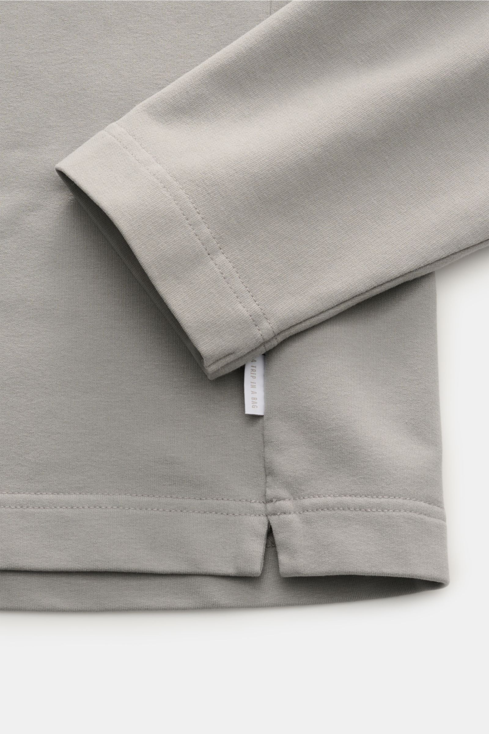 Close-up image of the sleeve and hem of the 04651/ A trip in a bag Rollkragenpullover 'If Turtle' navy, photographed from the side showing the fabric texture, soft cotton and microfiber blend, regular fit with an attached roll neck and a woven label in th