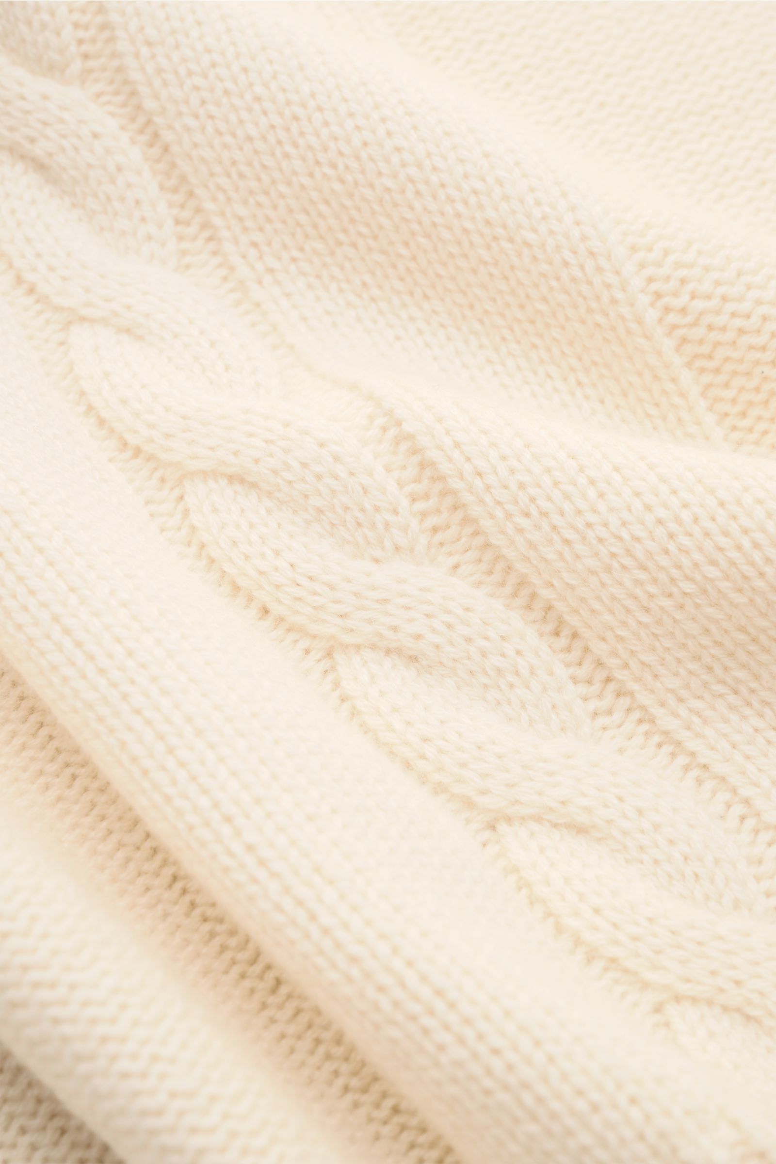 Nahaufnahme des von Braun Cashmere Rollkragenpullovers offwhite aus reiner Inneren Mongolei Cashmere mit Links- und Zopfstrickmuster.