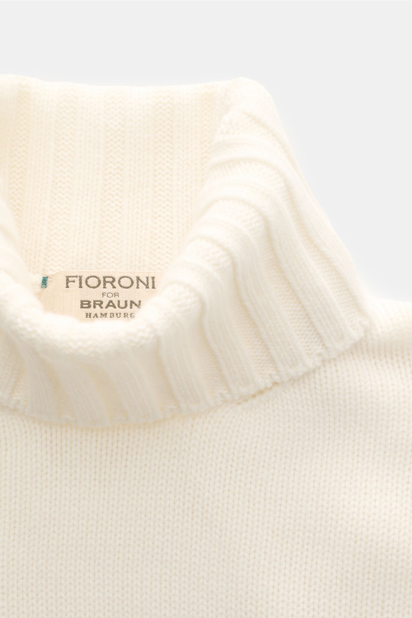 Close-up front view of Fioroni Cashmere Rundhalspullover creme, showcasing its soft, ribbed turtleneck collar and fine knit texture.

Souveräne Eleganz in ihrer luxuriösesten Form: Der Rollkragenpullover von FIORONI aus erlesenem Cashmere vereint meist