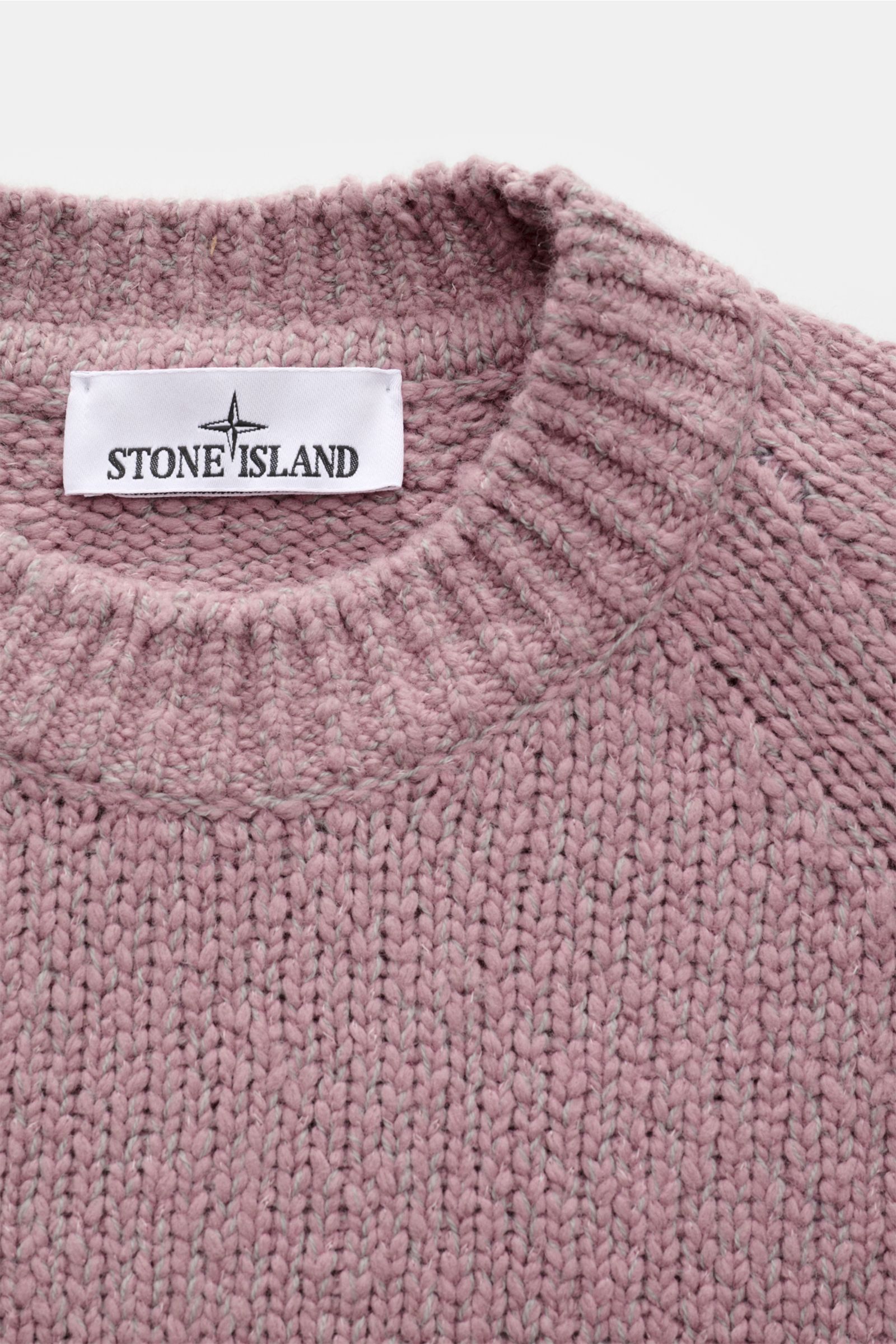 Close-up front view of Stone Island Crew neck jumper 'Fancy Yarn' antique pink mottled showing knit texture and brand label.

A stylish essential for the coming season: The casual jumper 'Fancy Yarn' in a warm wool blend by STONE ISLAND features a dist