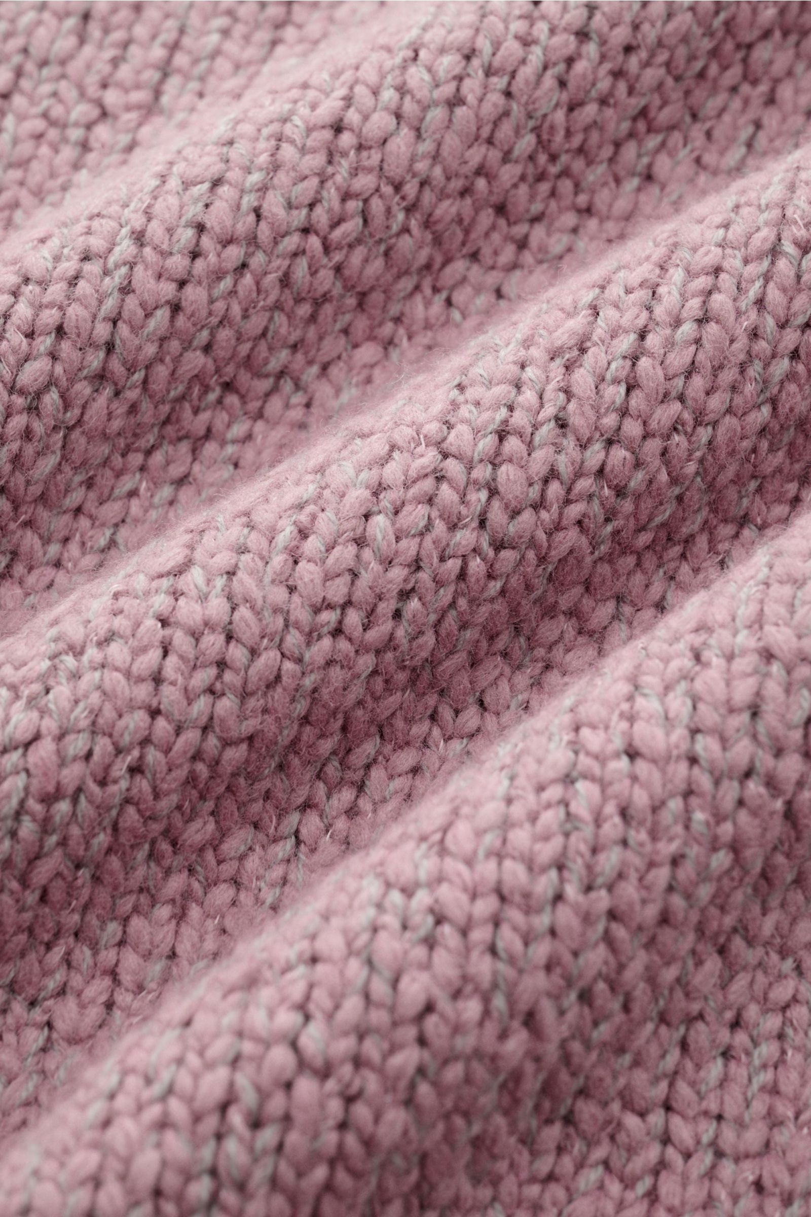 Close-up, angled view of the textured knit fabric of the Stone Island Crew neck jumper 'Fancy Yarn' antique pink mottled, showing its warm wool blend and distinctive effect yarn knit.

A stylish essential for the coming season: The casual jumper 'Fancy