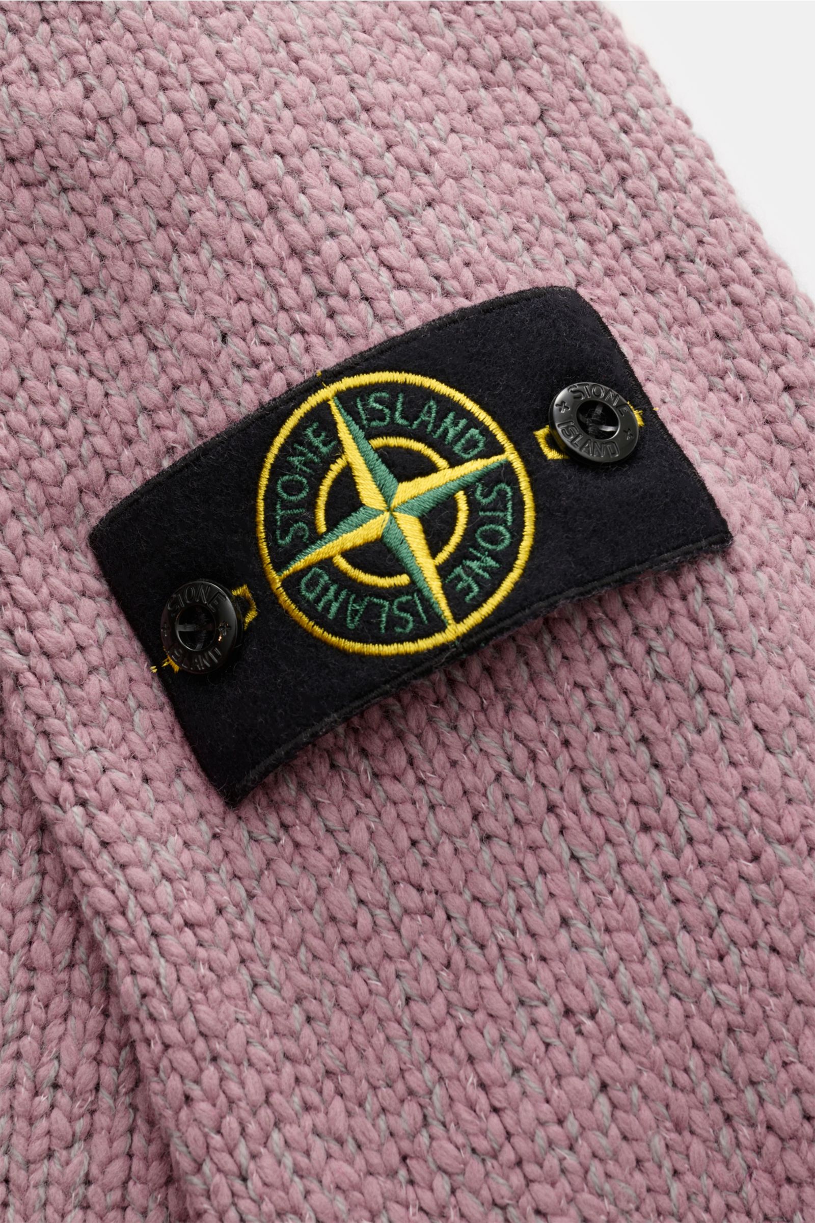 Stone Island Crew neck jumper 'Fancy Yarn' antique pink mottled shown in close-up from above, highlighting the knit texture and iconic compass badge on the sleeve. 

A stylish essential for the coming season: The casual jumper 'Fancy Yarn' in a warm wo