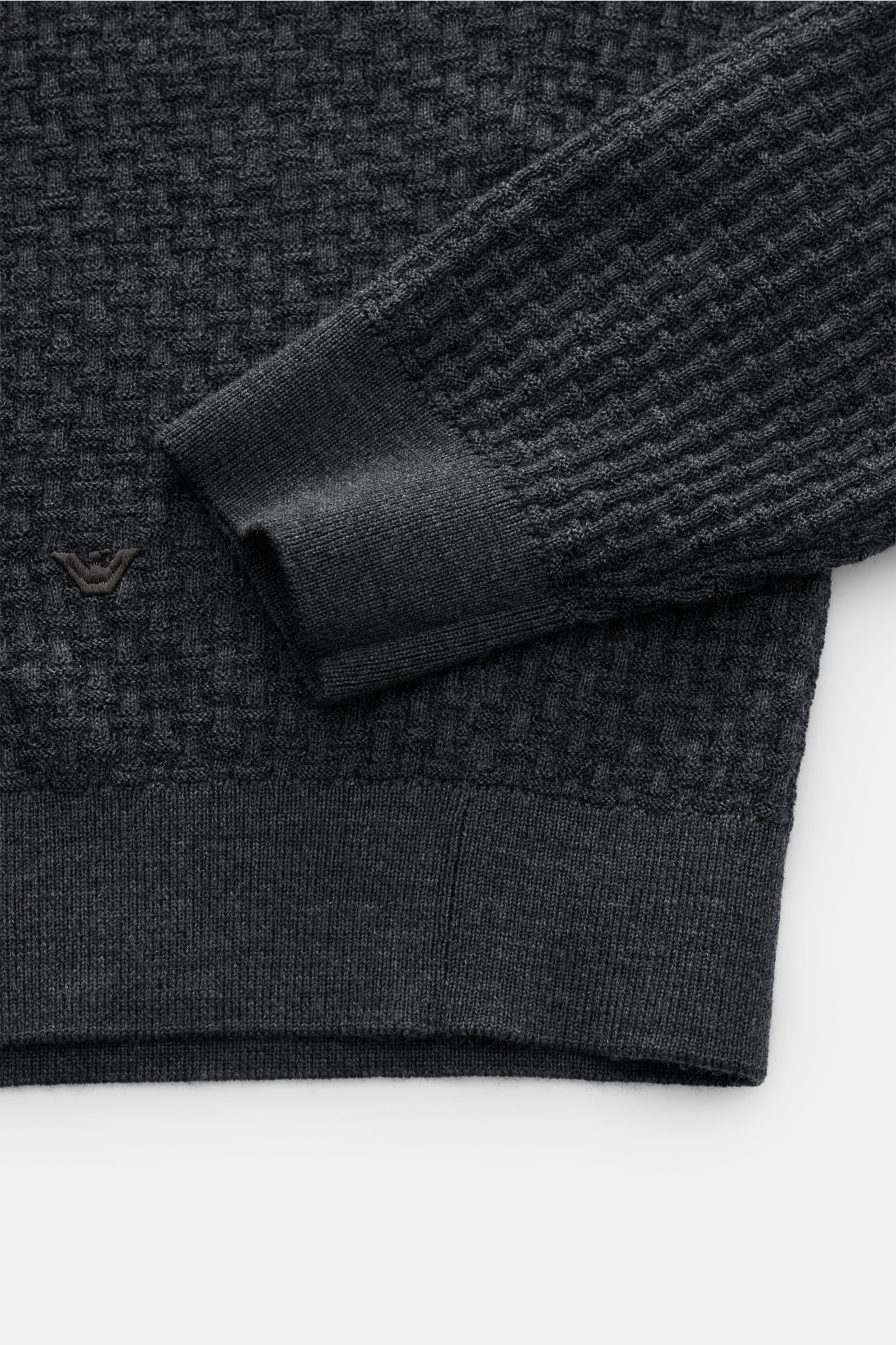 Emporio Armani Feinstrick-Rundhalspullover dunkelgrau, fein strukturiert, weicher Griff, tonales Logo-Stitching, Rippbündchen, Detailaufnahme von Ärmel und Saum.