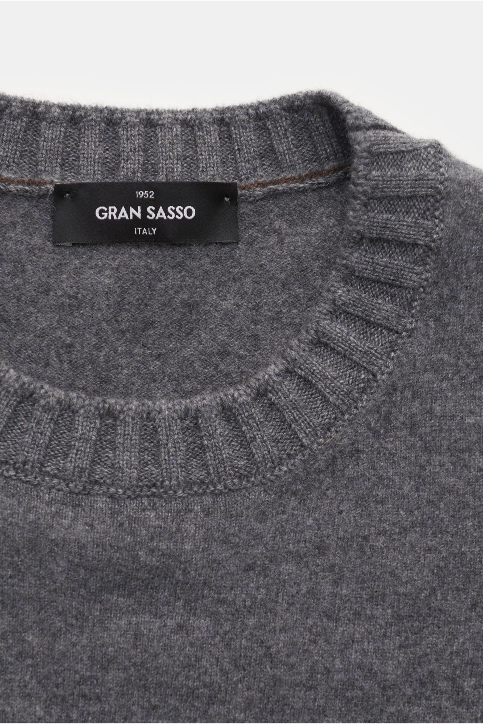 Close-up front view of the Gran Sasso Cashmere crew neck jumper dark grey mottled, showing pure cashmere, very soft feel, slightly fulled fabric, fine knit, regular fit, crew neck, and comfortable ribbed bands.