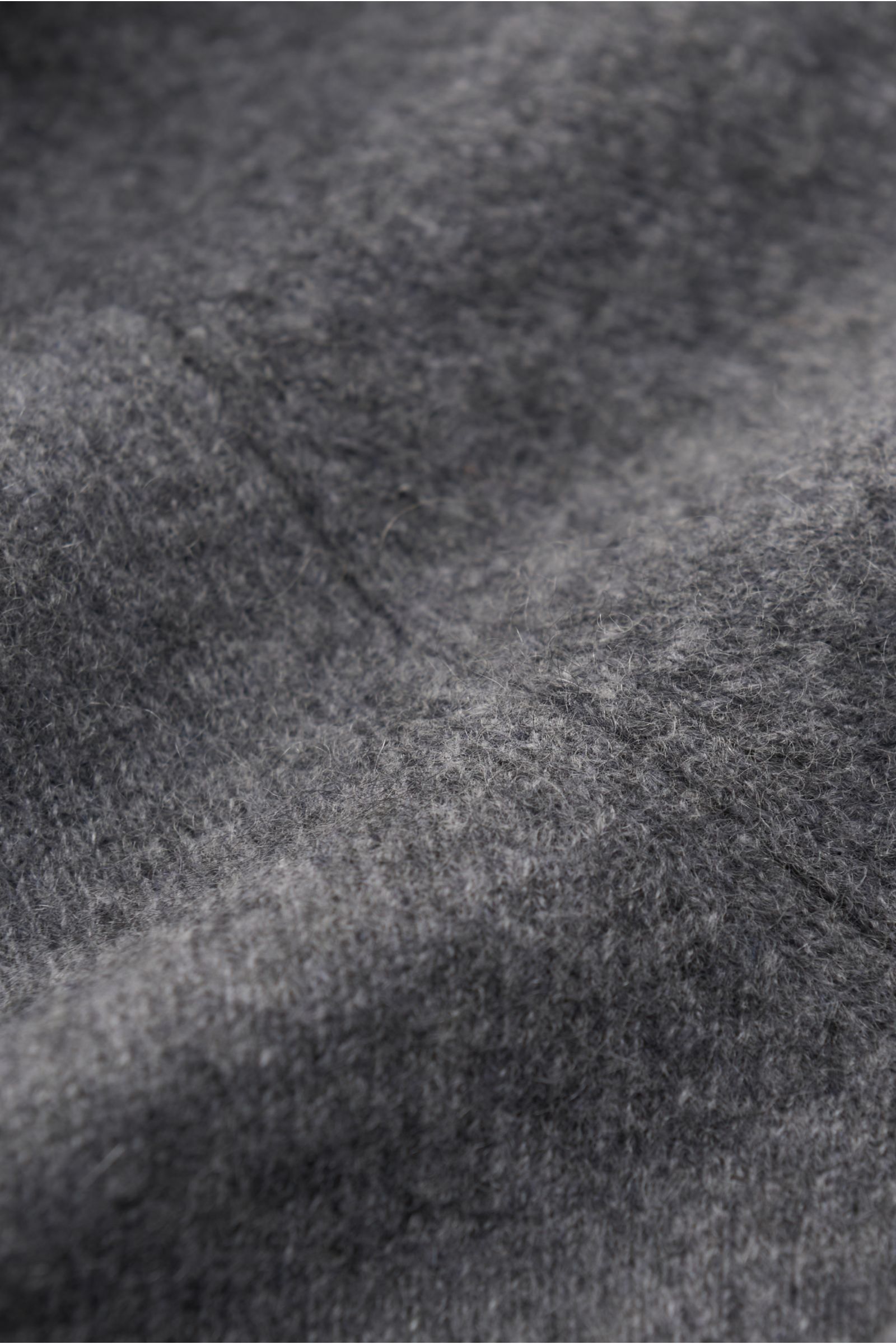Gran Sasso Cashmere crew neck jumper dark grey mottled shown in close-up from above, featuring pure cashmere, very soft feel, slightly fulled fabric, fine knit, regular fit, crew neck, comfortable ribbed bands.