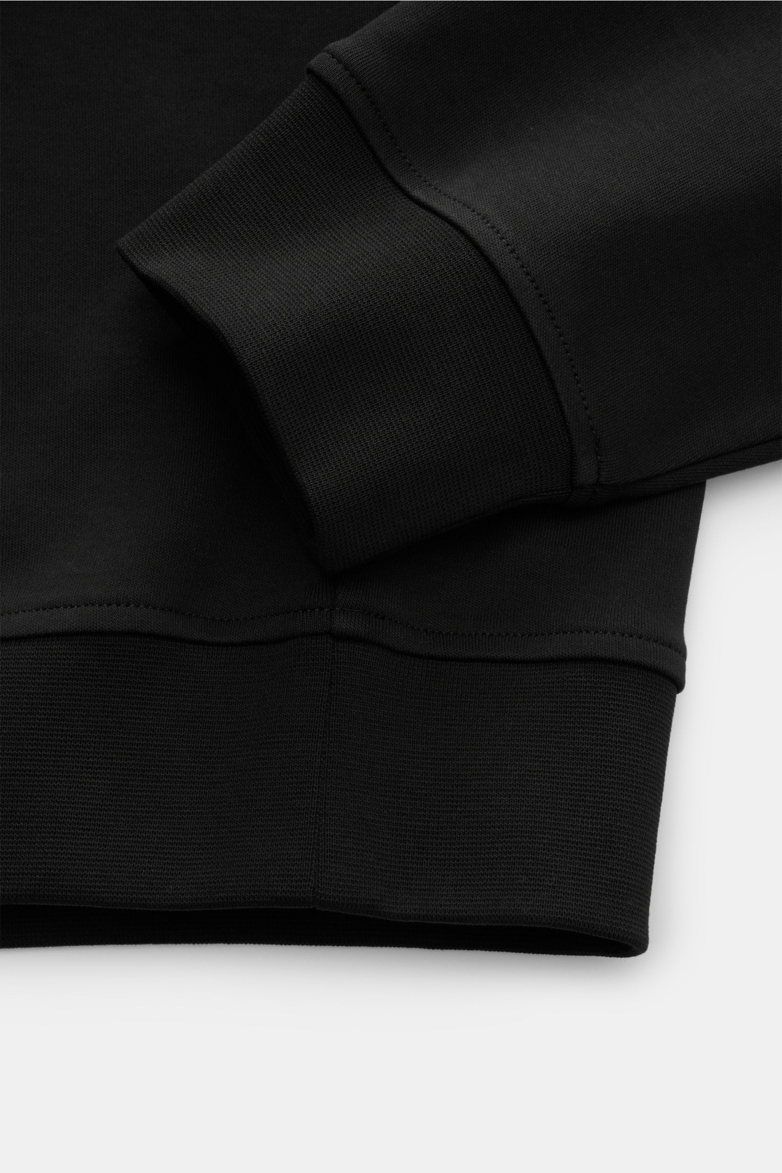 Close-up side view of the black Moose Knuckles Crew neck sweatshirt 'Dalon Crew' showing cuff and hem with wide bands in pure cotton.

Refined sportswear: A practical zip pocket featuring the signature MOOSE KNUCKLES logo in metal stands out on the fro