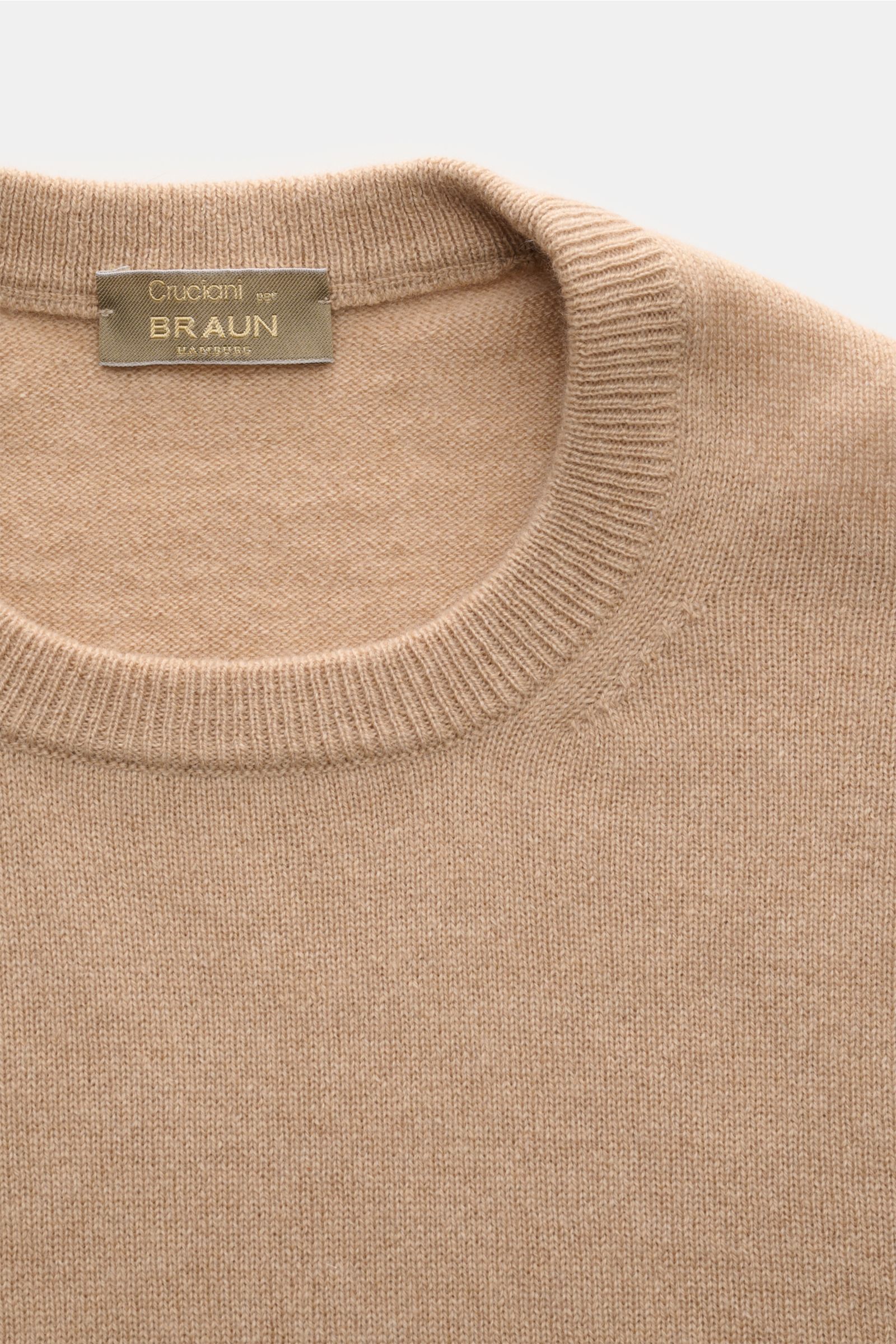 Close-up front view of the Cruciani Cashmere crew neck jumper beige, showing the fine knit texture and elasticated rib knit crew neck collar. CRUCIANI has used the finest soft cashmere yarn to create a classic crew neck jumper that is warm and versatil