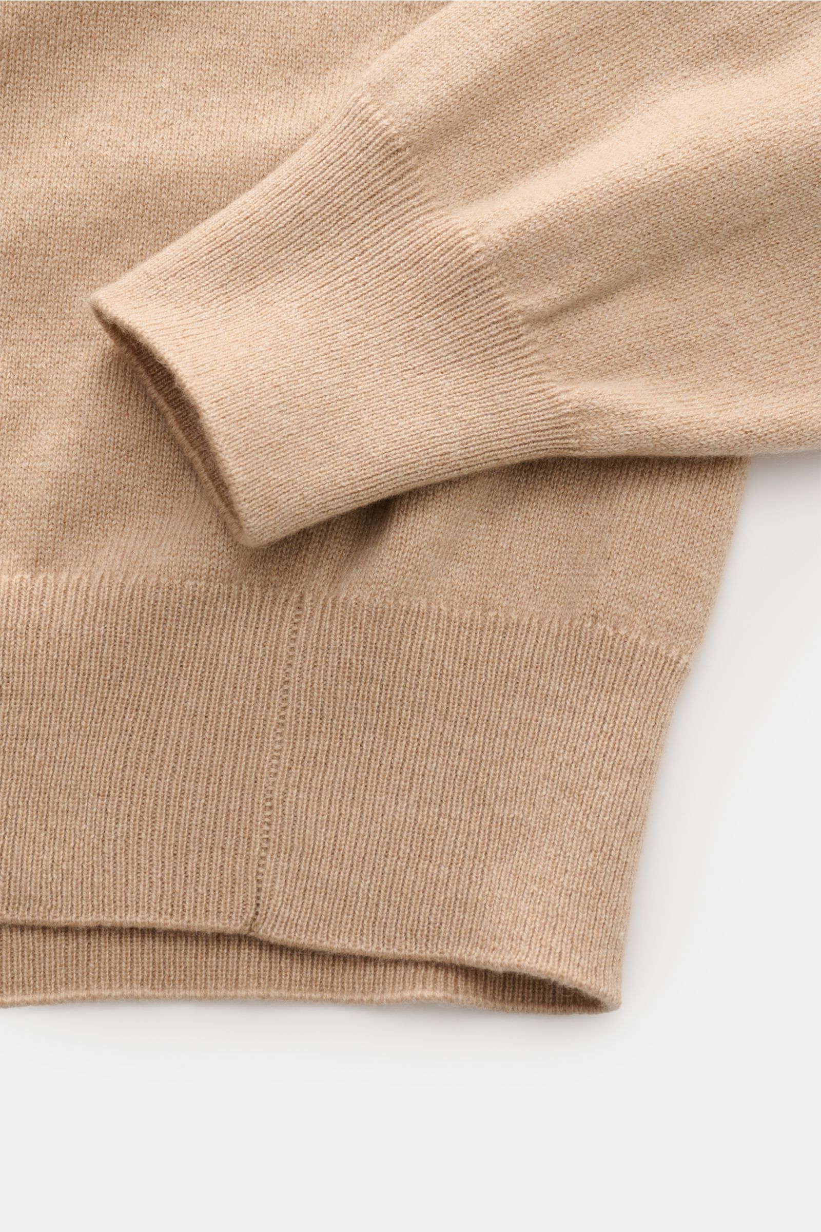 Close-up image from above showing the sleeve and hem of the Cruciani Cashmere crew neck jumper beige, highlighting the fine knit and elasticated rib knit bands.

CRUCIANI has used the finest soft cashmere yarn to create a classic crew neck jumper that 