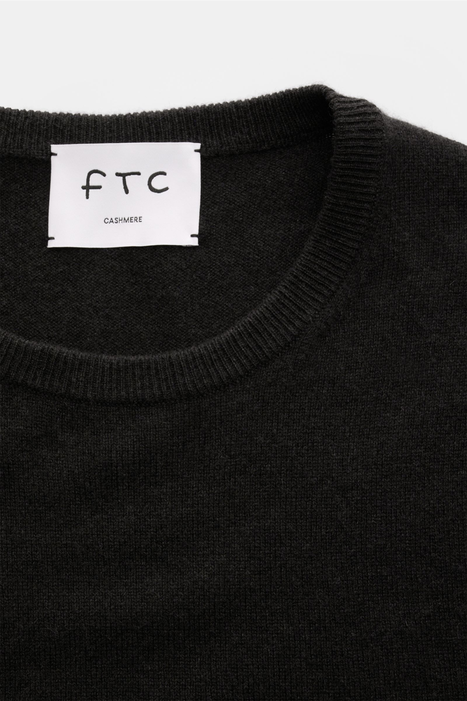 Close-up top-down view of FTC Cashmere crew neck jumper dark brown showing fine knit crew neck and label.

The feel of ultra soft cashmere fabric makes this timeless crew neck jumper by sustainable knitwear label FTC CASHMERE a knitted favourite for yo