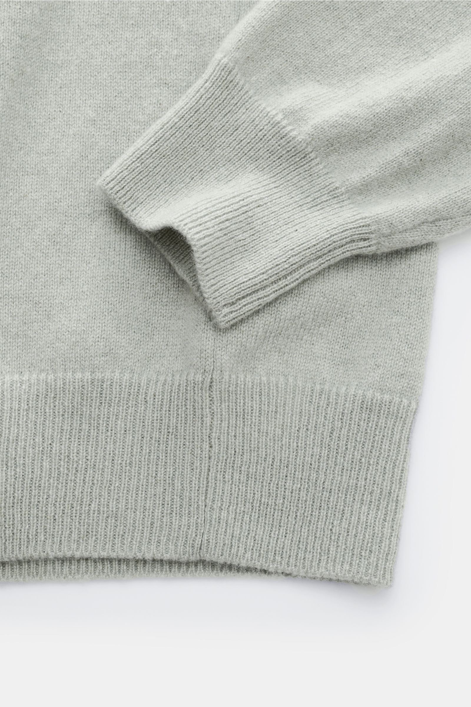 Close-up top-down view of the FTC Cashmere crew neck jumper grey-green showing ribbed bands on sleeve cuff and hem, fine knit fabric.

The feel of ultra soft cashmere fabric makes this timeless crew neck jumper by sustainable knitwear label FTC CASHMER