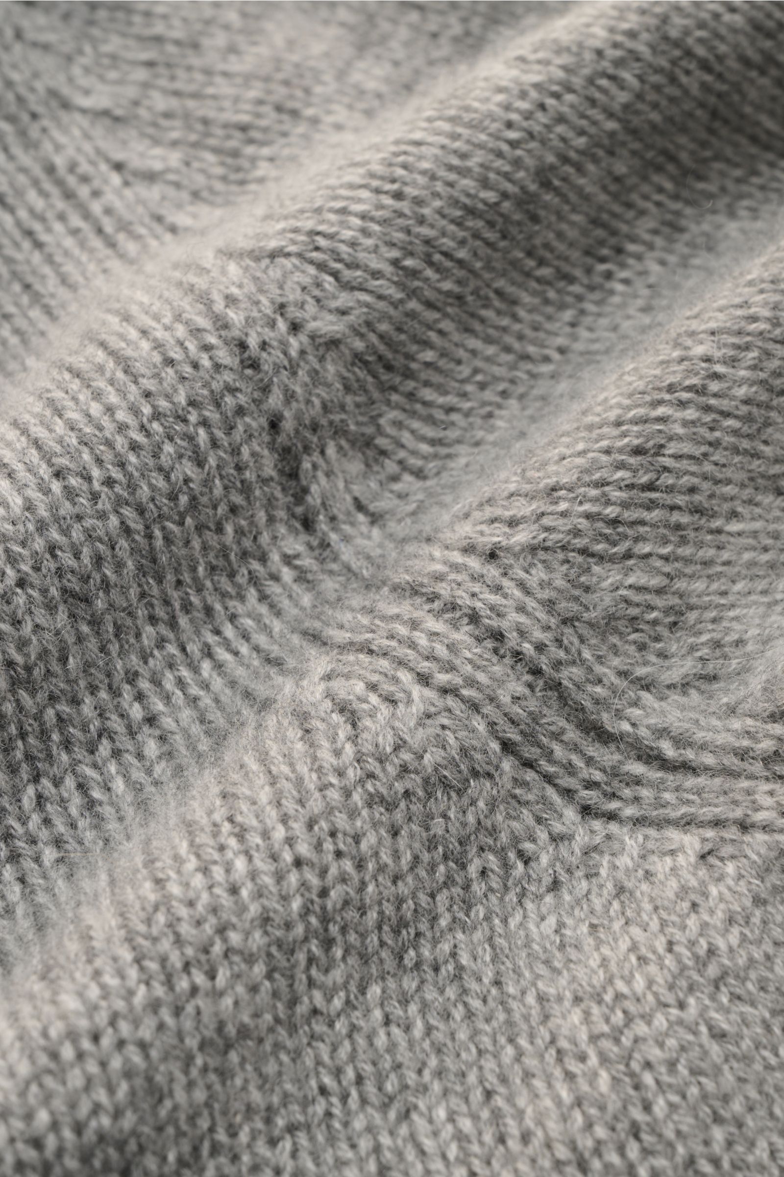 Close-up, angled view of the soft, mid-fine knitted texture of the Bruno Manetti Cashmere Rundhalspullover grau meliert, showcasing its pure cashmere, slim fit, round neckline, and comfortable ribbed cuffs, a favorite piece combining understated elegance 