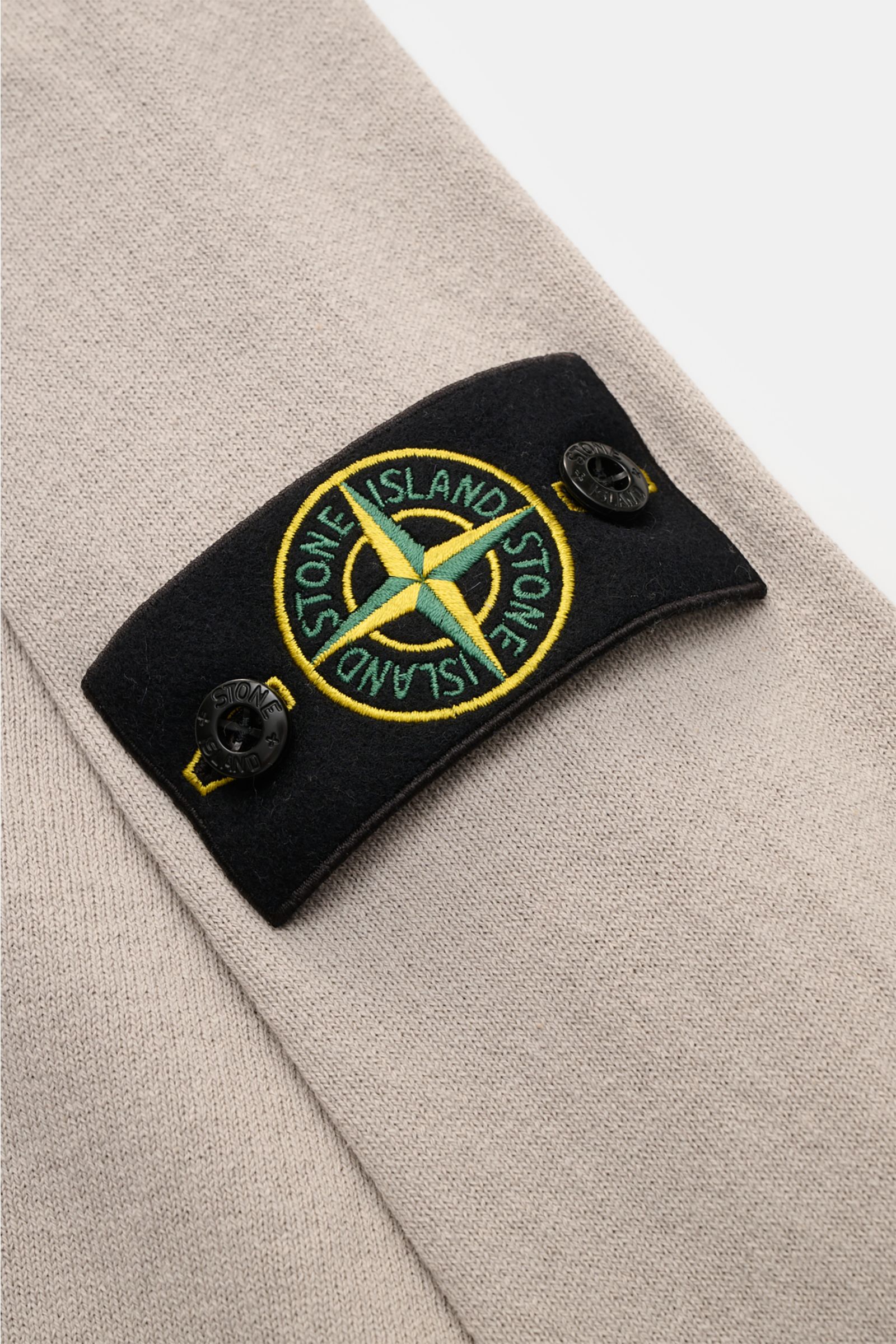 Close-up angled view of Stone Island Crew neck jumper light grey showing the signature compass badge on fine knit cotton fabric.

STONE ISLAND has transformed this crew neck jumper into a sophisticated basic with fine details like the rolled hem and wi