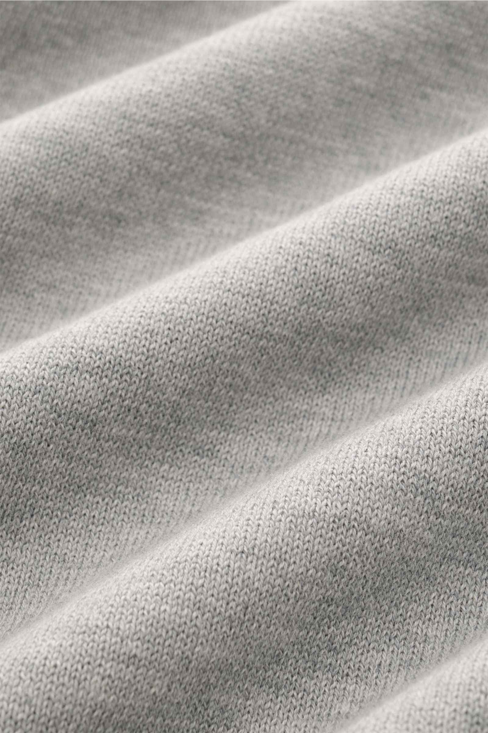 Close-up front view of Stone Island Crew neck jumper light grey mottled showing fine knit, soft cotton fabric texture, and ribbed elasticated bands.

Timeless classic: This knitted jumper by STONE ISLAND is a casual spring companion thanks to its comfo
