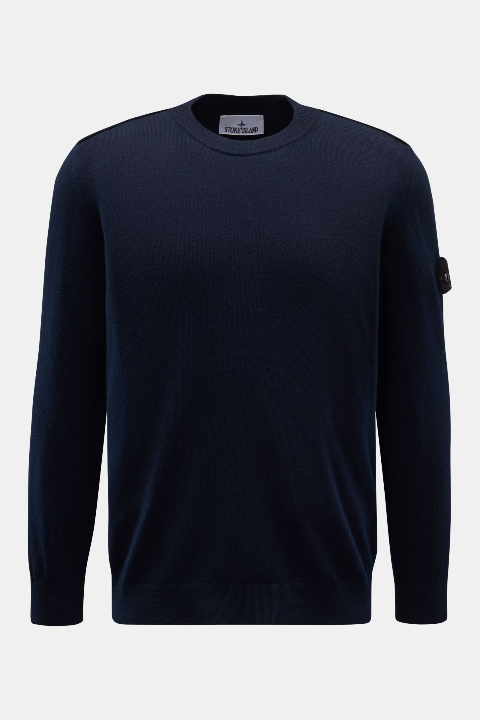 Front view of Stone Island Crew neck jumper navy in pure wool, featuring a soft, fine knit, regular fit, crew neck, tonal compass badge on upper sleeve, and elasticated ribbed bands. 

A timeless piece from STONE ISLAND: If you want to create a warm, s