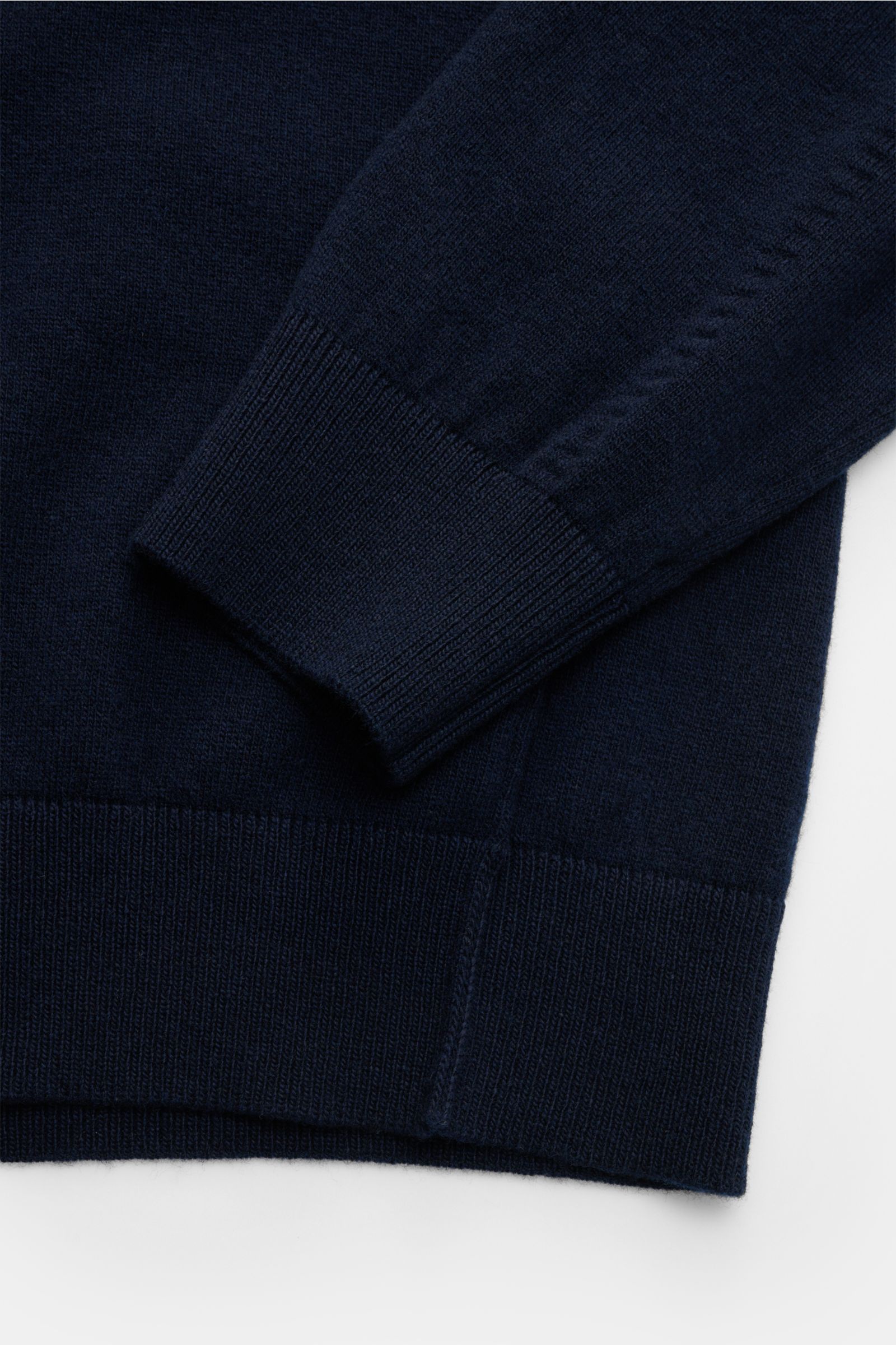 Close-up front-side view of Stone Island Crew neck jumper navy showing elasticated ribbed cuffs and hem in fine pure wool knit.

Description: 
A timeless piece from STONE ISLAND: If you want to create a warm, sporty look, you can’t go wrong with this c