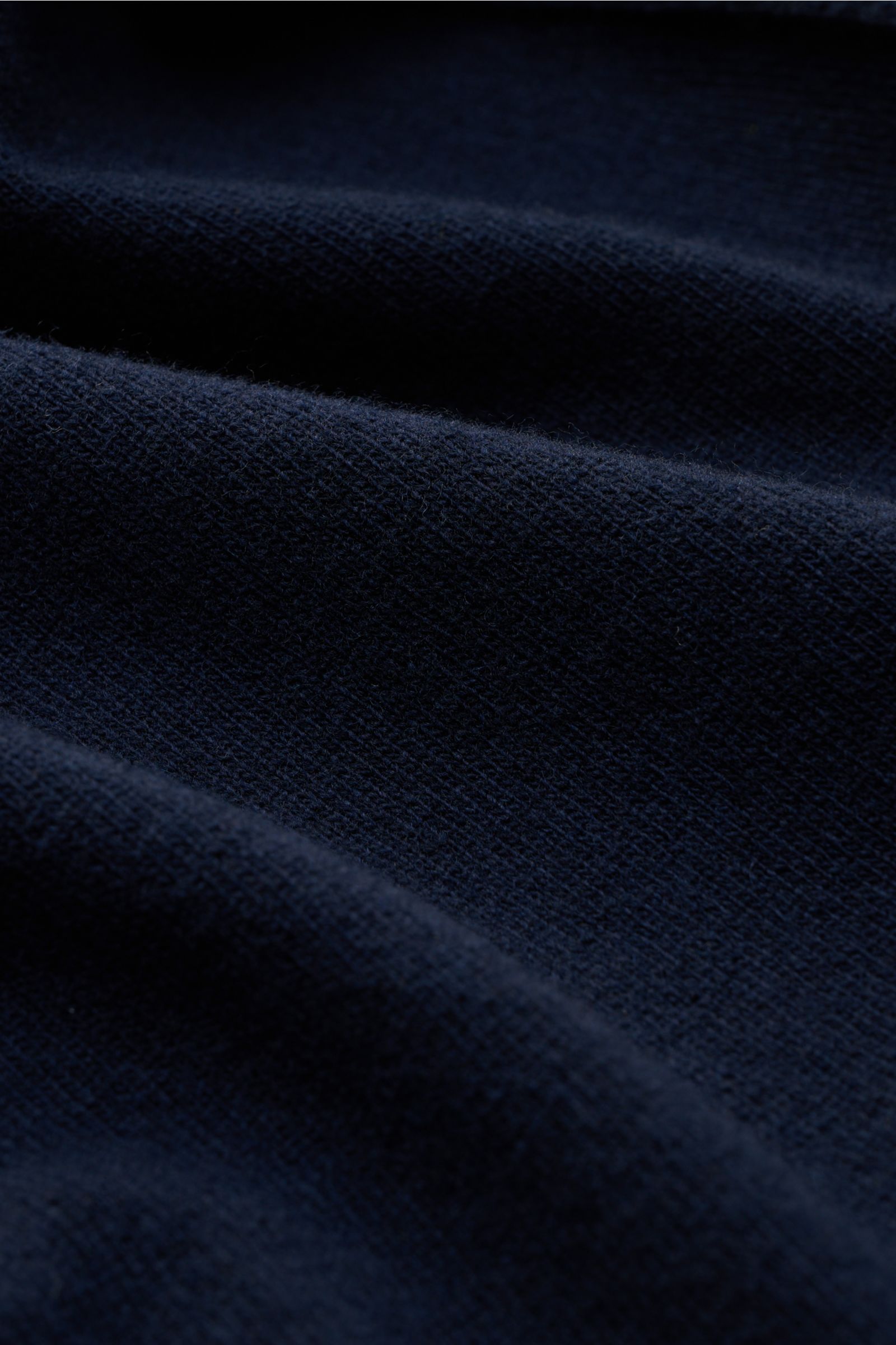 Close-up fabric texture of the Stone Island Crew neck jumper navy, showing fine pure wool knit from a front angled perspective.

Description: 
A timeless piece from STONE ISLAND: If you want to create a warm, sporty look, you can’t go wrong with this c