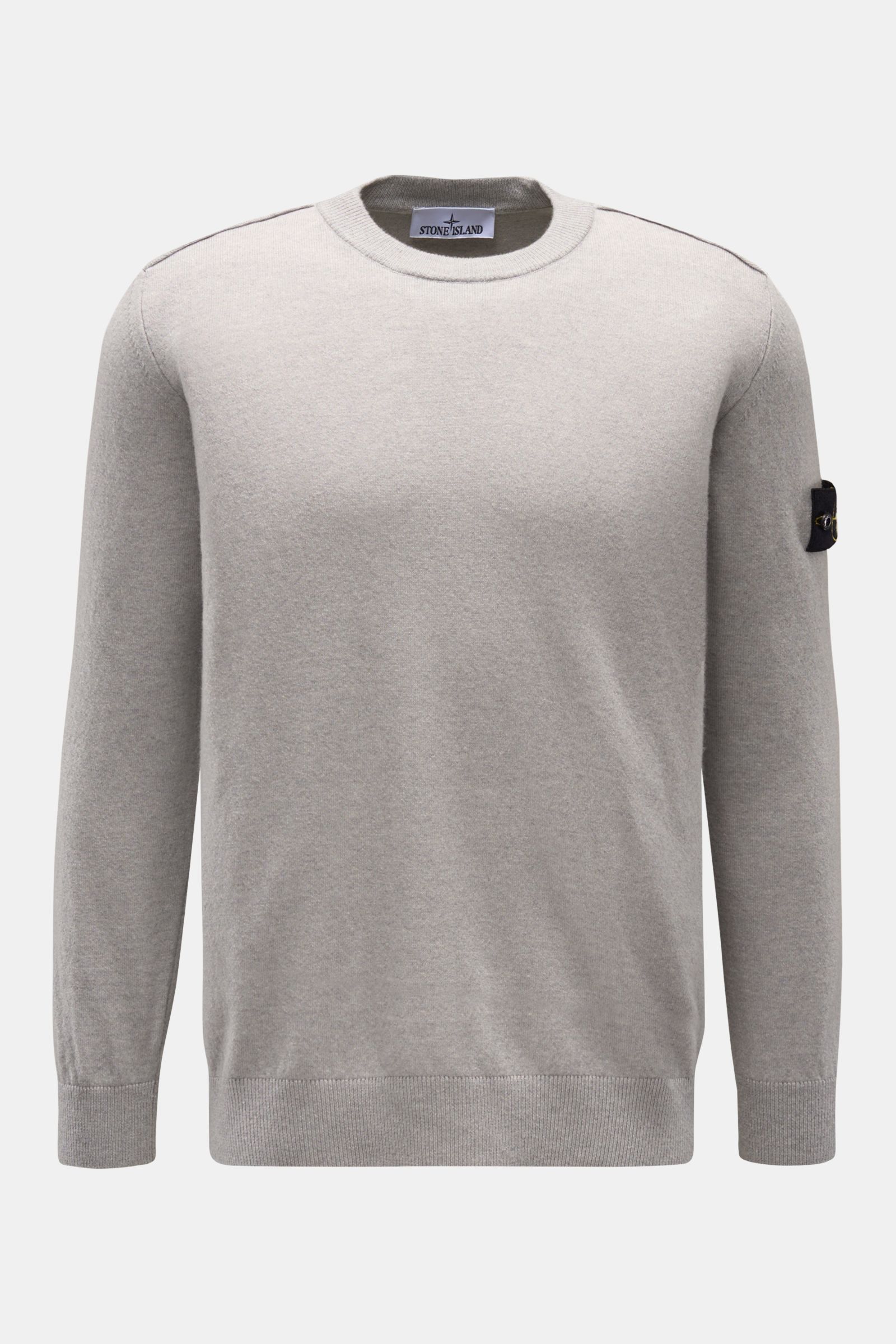 Stone Island Crew neck jumper grey shown from the front on a plain background, featuring pure wool knit, soft feel, fine knit, regular fit, crew neck, tonal compass badge on the upper sleeve, and elasticated ribbed bands. 

A timeless piece from STONE 