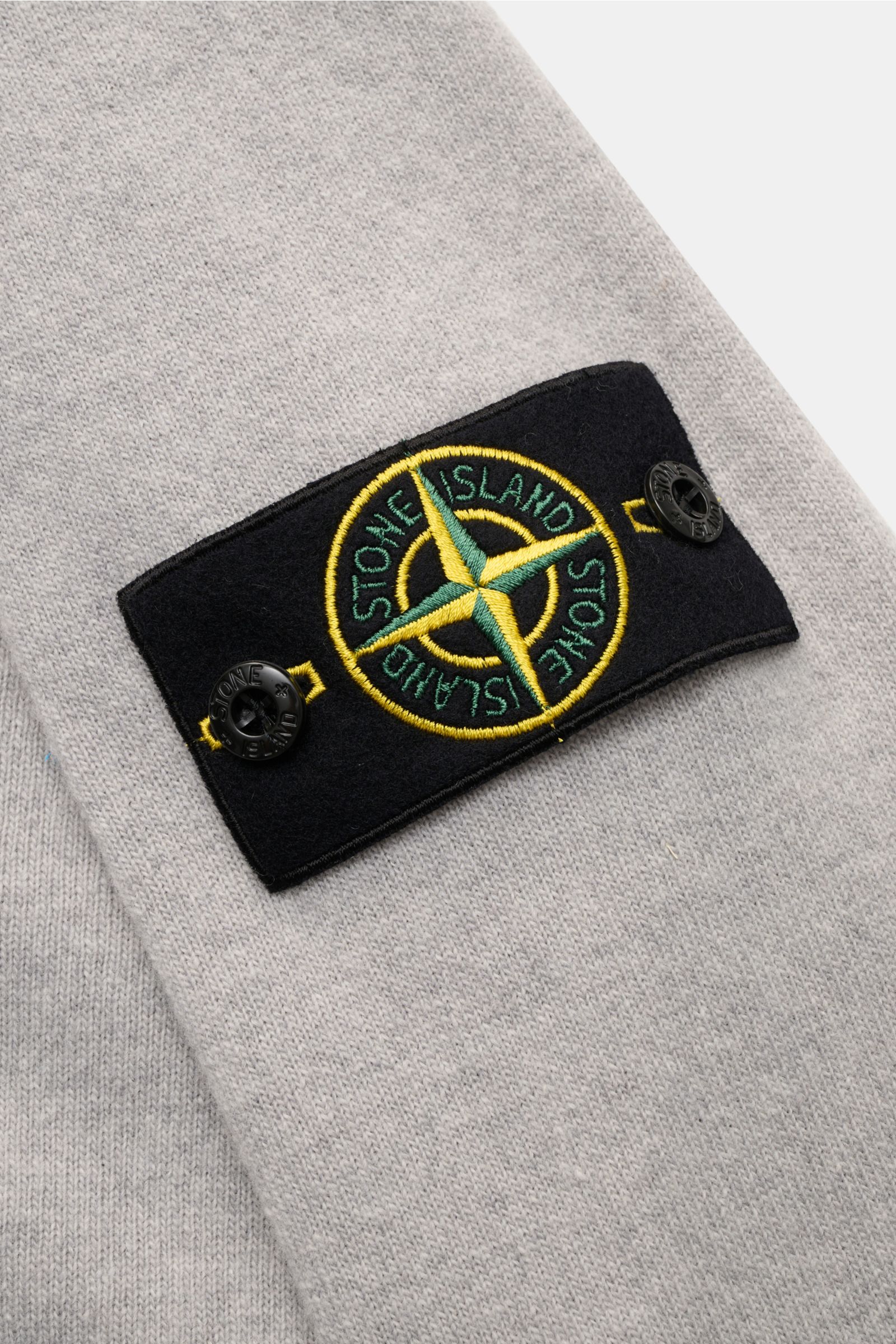 Stone Island Crew neck jumper grey shown in close-up from the side, featuring tonal compass badge on upper sleeve, pure wool knit, soft feel, fine knit, regular fit, crew neck, elasticated ribbed bands. 

A timeless piece from STONE ISLAND: If you want