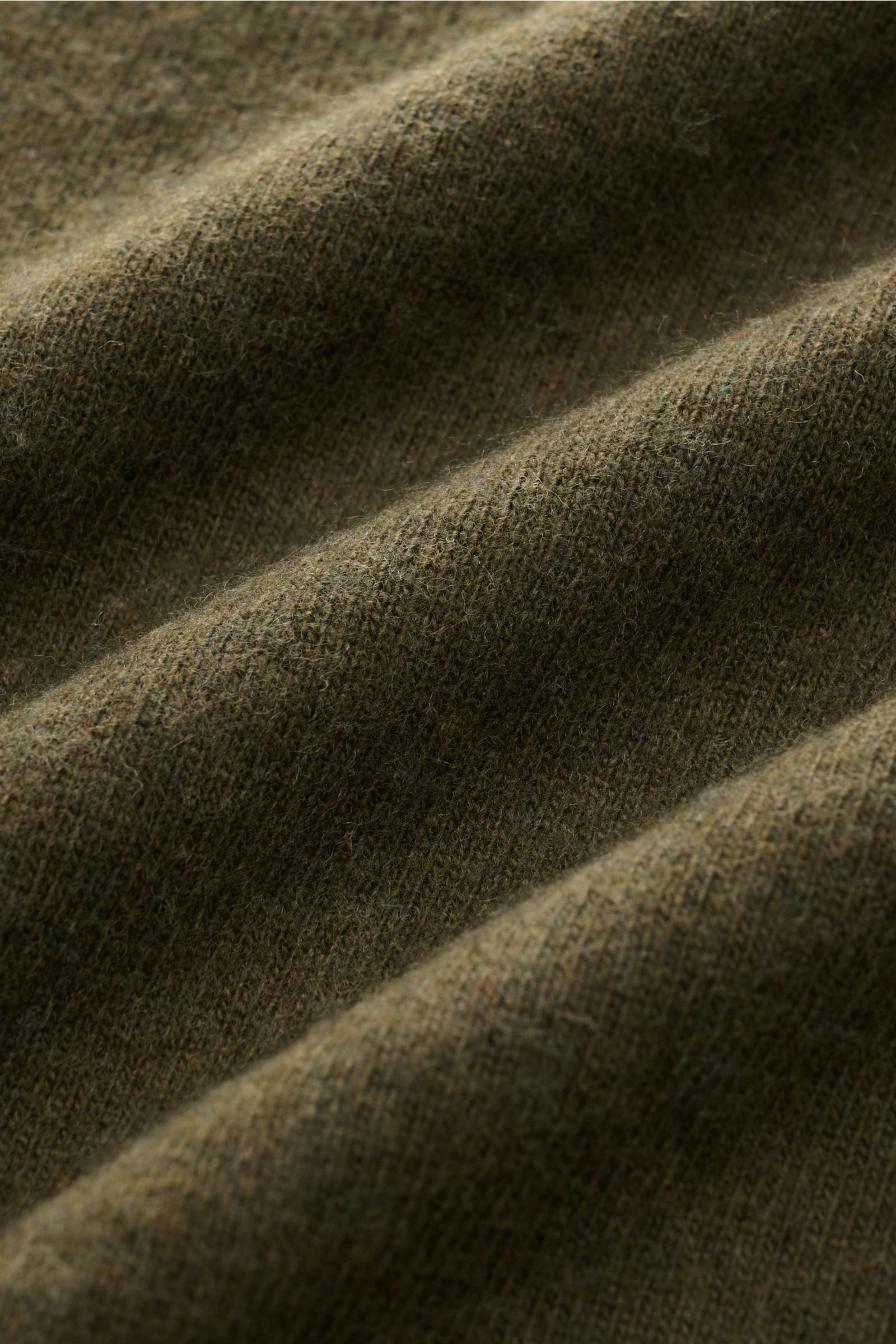 Close-up angled view of the 04651/ A trip in a bag Crew neck jumper 'Boiled Crew' olive fabric showing fine knit texture and soft wool-viscose blend. Stylish comfort for cold days: This crew neck jumper by 04651/ A TRIP IN A BAG is a versatile piece with 