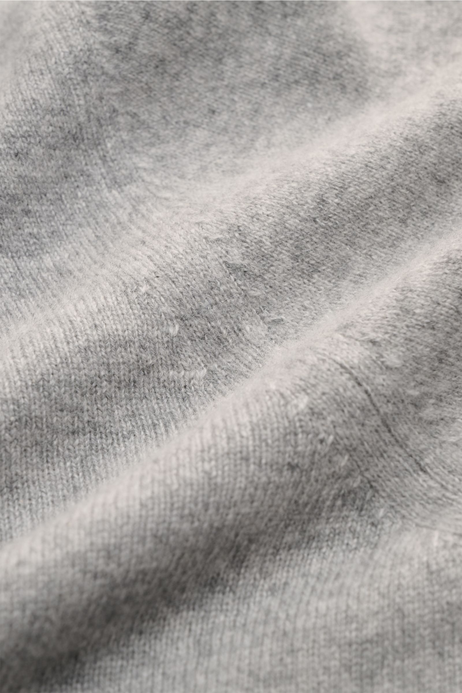 Fioroni Cashmere Rundhalspullover grau meliert, Nahaufnahme schräg von oben, weiches Baby-Cashmere, feines Strickbild, Slim Fit, Rundhalsausschnitt, flexible Rippbündchen.