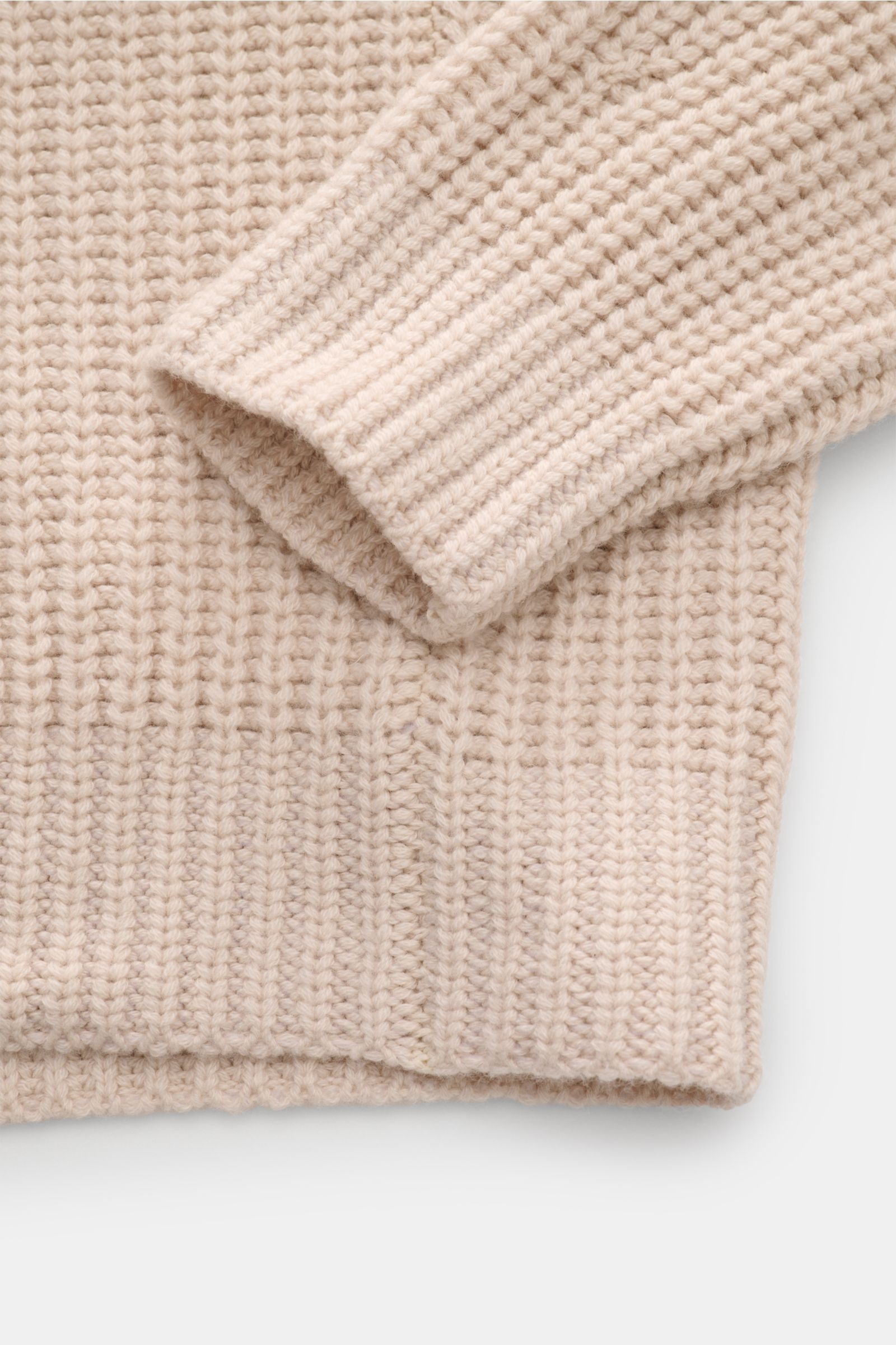 Close-up top-down view of the sleeve and hem of the Iris von Arnim Cashmere Rundhalspullover 'Aurenzo' sand, showcasing its voluminous patent knit, slim fit, round neckline, tongue raglan sleeves, and comfortable ribbed cuffs made from pure, luxuriously s