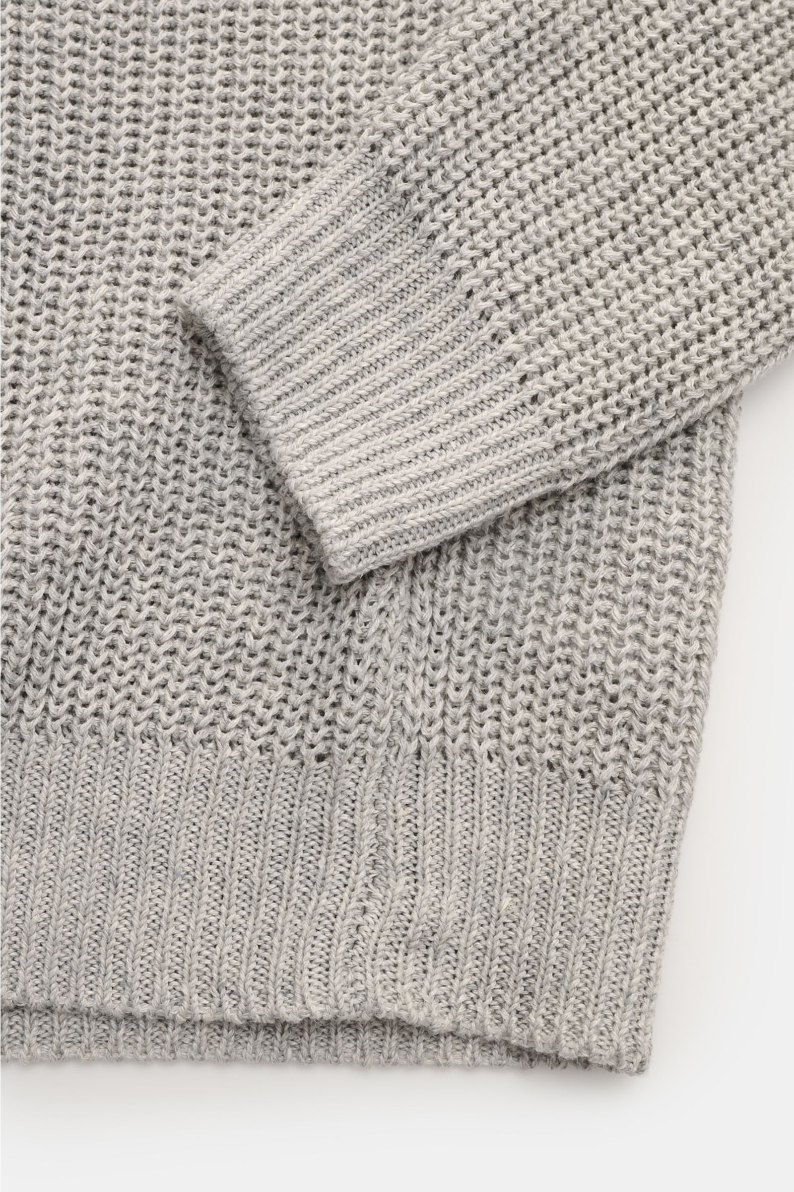 Close-up front view of Iris von Arnim Crew neck jumper 'Leovan' grey mottled showing voluminous brioche knit, ribbed cuff and hem.  

Description:  
A luxurious knitwear essential: With its voluminous brioche knit in the finest linen-cotton blend, this