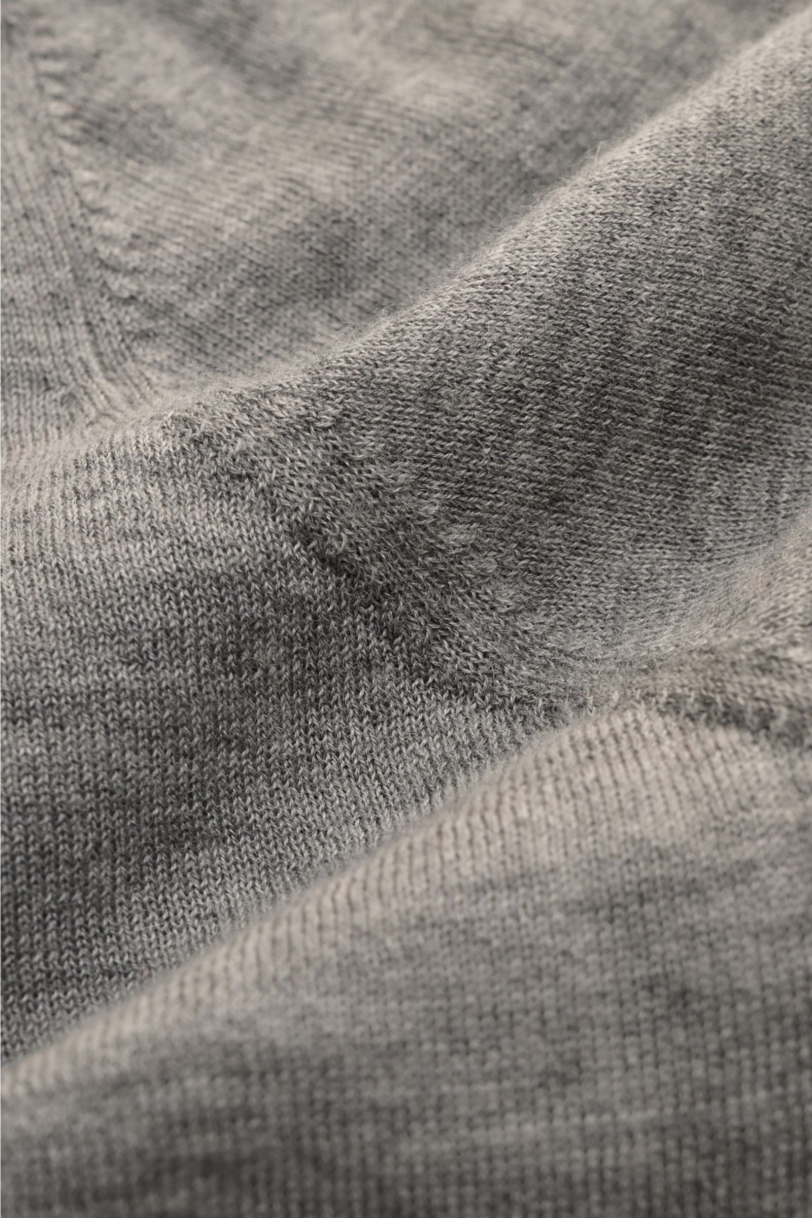 Close-up view of the Soft Goat Cashmere crew neck jumper grey mottled, showing fine knit texture and soft feel from a detailed angle.

Description: Sustainably produced and certified: Young label SOFT GOAT shows how it’s done with its super lightweight