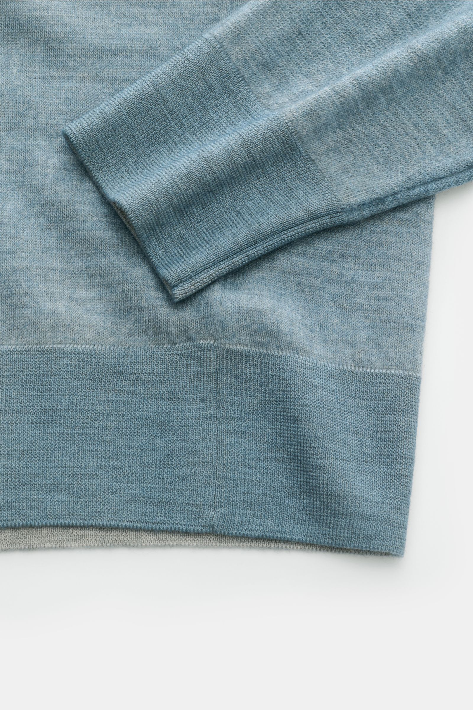 Close-up top-down view of the Colombo Cashmere crew neck jumper smoky blue showing sleeve and wide ribbed hem in fine, lightweight knit.

Make statement in stylish elegance: This jumper by COLOMBO in exquisite cashmere feels as light as a feather in th
