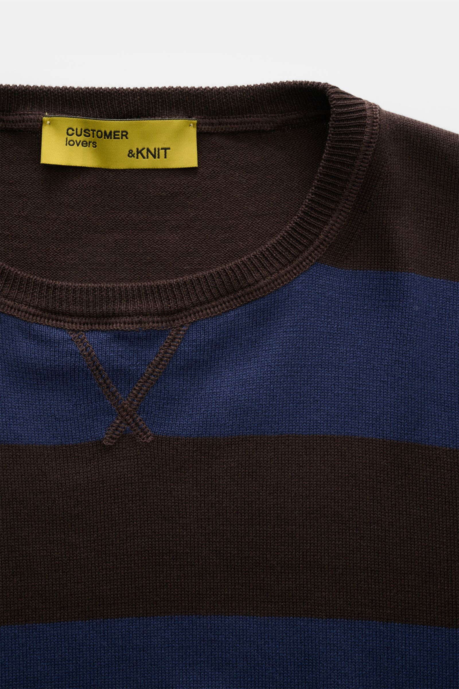 Close-up front view of B.F. Knitwear Crew neck jumper navy/dark brown striped with fine knit, quilted stitching, and elasticated rib bands.

Description: Lightweight summer knit by experts B.F. KNITWEAR: This fine knit crew neck jumper in cotton with bloc