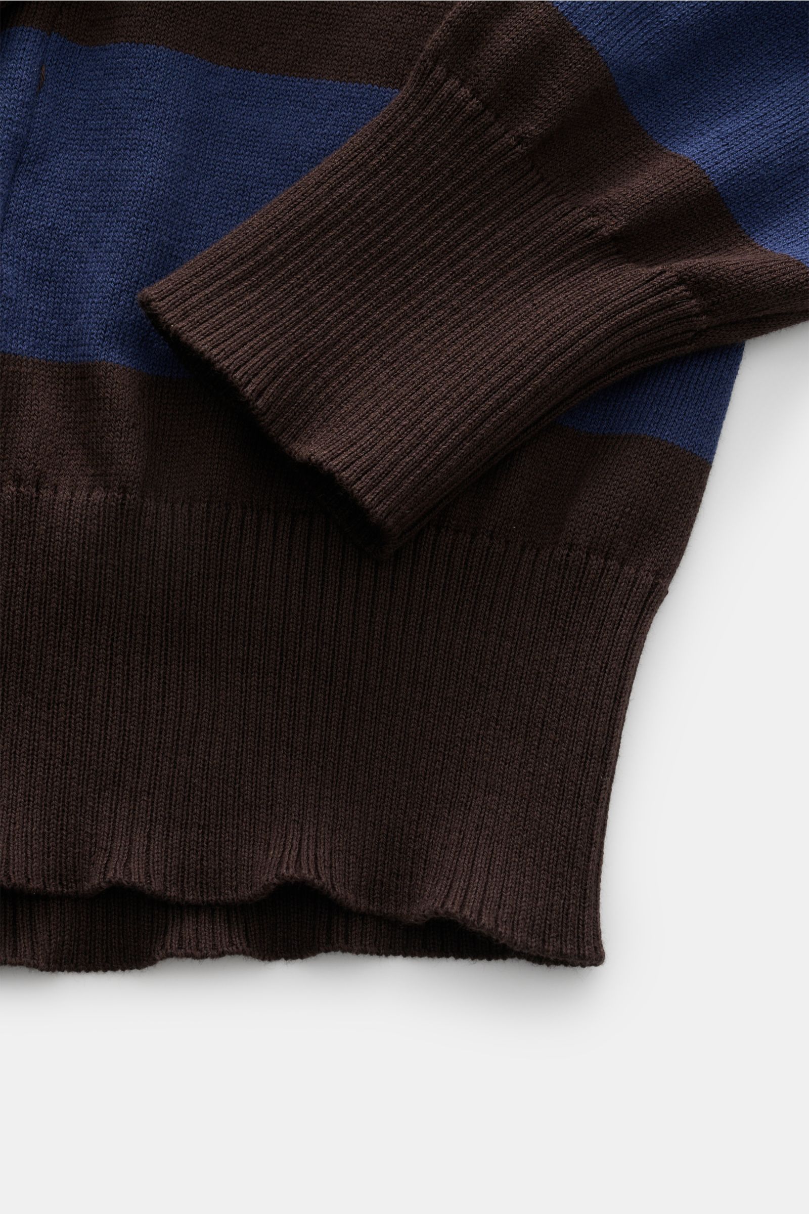 Close-up front view of B.F. Knitwear Crew neck jumper navy/dark brown striped showing quilted stitching and rib knit cuffs.

Description: 
Lightweight summer knit by experts B.F. KNITWEAR: This fine knit crew neck jumper in cotton with block stripes gi