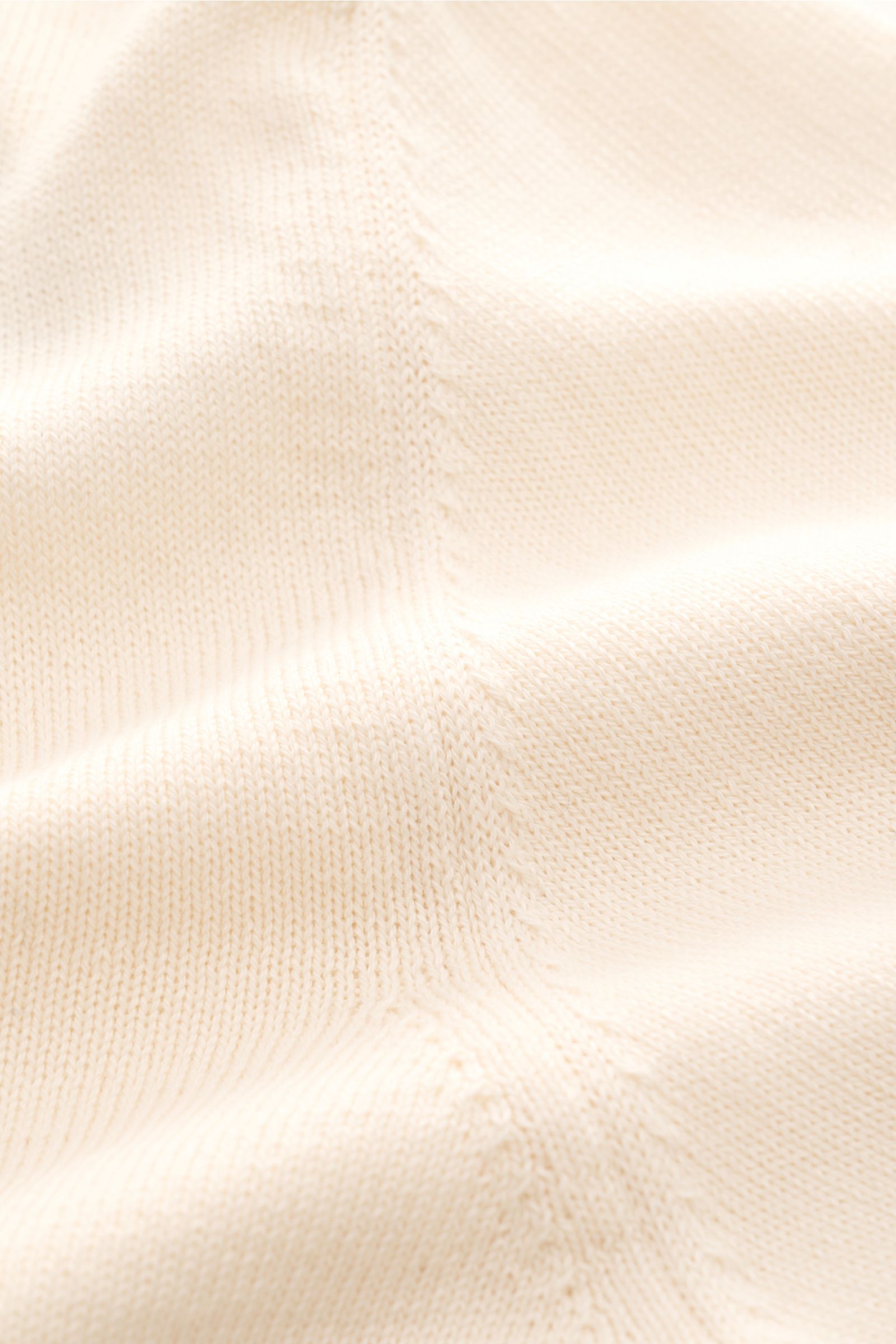 Close-up front view of B.F. Knitwear Crew neck jumper cream showing fine knit, ribbed bands, and soft pure cotton texture. 

A versatile essential for spring: This crew neck jumper in pure cotton by B.F. KNITWEAR enhances any wardrobe with a clean, tim