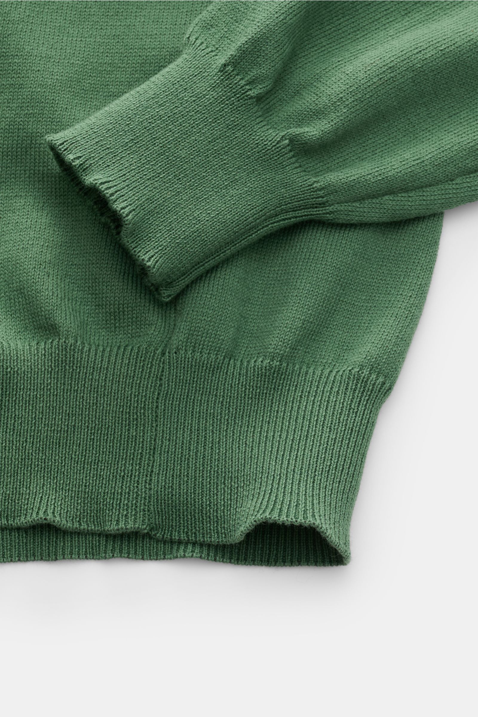 Close-up top-down view of B.F. Knitwear Crew neck jumper green showing fine knit, ribbed bands, and soft pure cotton fabric.