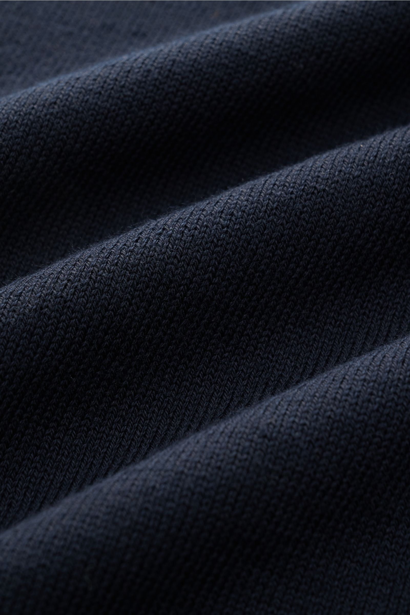 Close-up front view of B.F. Knitwear Crew neck jumper dark navy showing fine knit pure cotton fabric with soft feel and ribbed texture.

Description:
A versatile essential for spring: This crew neck jumper in pure cotton by B.F. KNITWEAR enhances any w