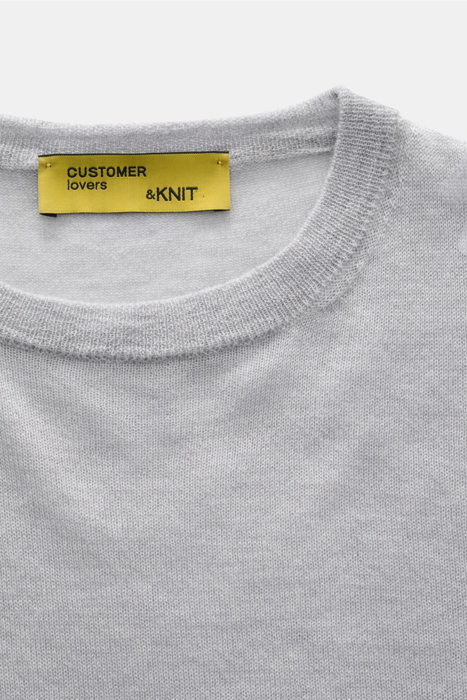 Close-up front view of B.F. Knitwear Cashmere crew neck jumper light grey mottled showing fine, airy knit and elasticated rib knit crew neck band.

Lightweight summer cashmere from knitwear experts B.F. KNITWEAR: enhance your spring wardrobe with a dur