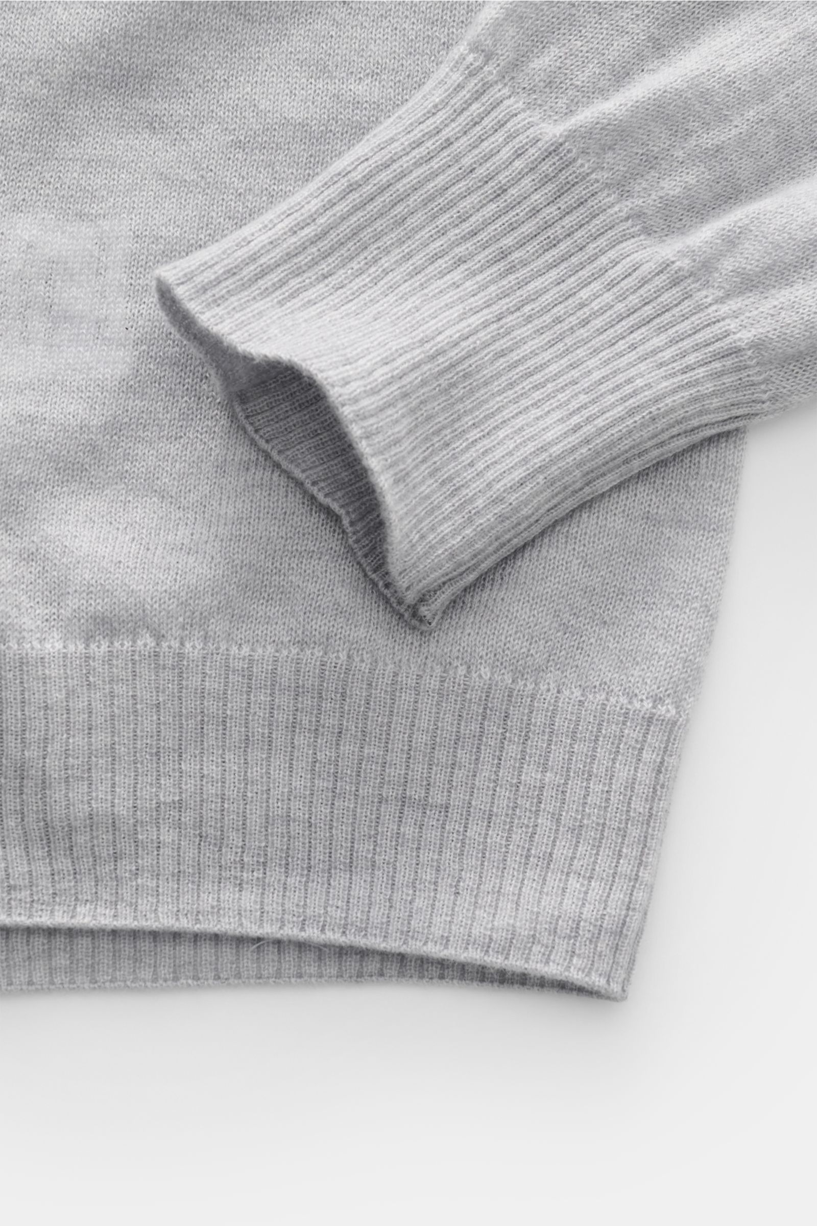 Close-up top-down view of B.F. Knitwear Cashmere crew neck jumper light grey mottled showing fine, airy knit with elasticated rib knit bands.

Lightweight summer cashmere from knitwear experts B.F. KNITWEAR: enhance your spring wardrobe with a durable,