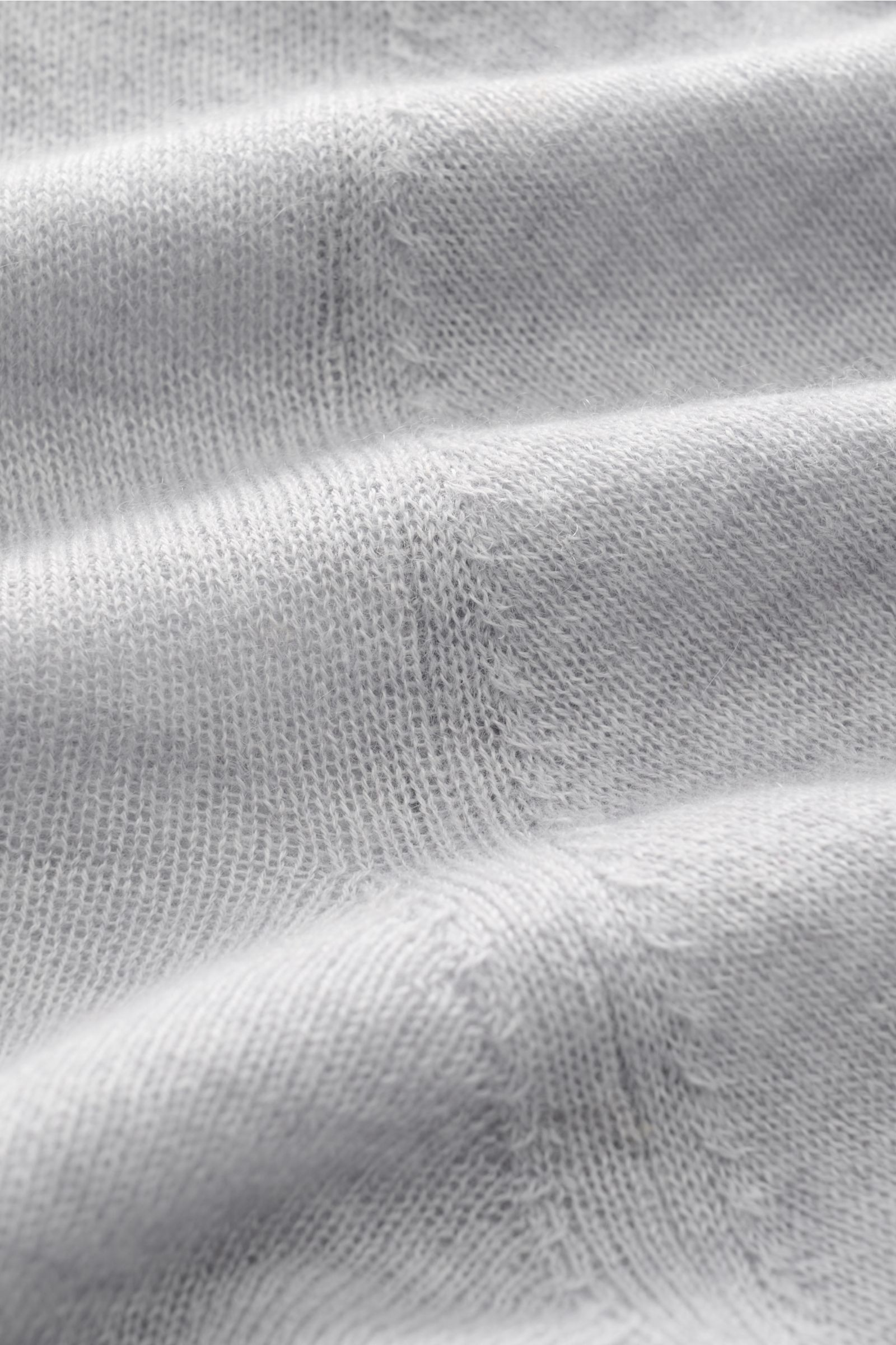 Close-up front view of B.F. Knitwear Cashmere crew neck jumper light grey mottled showing fine, airy knit texture and soft pure cashmere fabric.

Description: Lightweight summer cashmere from knitwear experts B.F. KNITWEAR: enhance your spring wardrobe wi