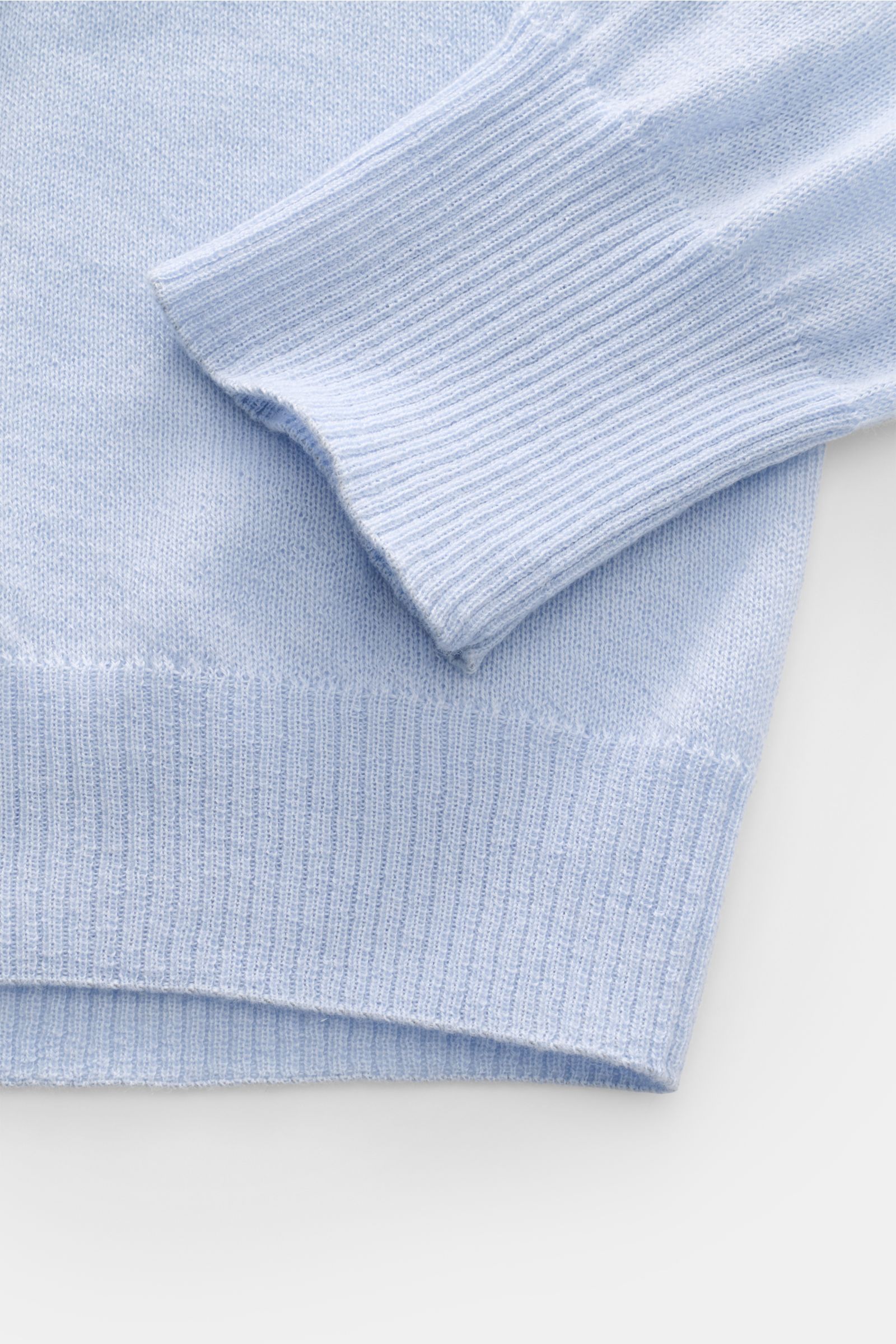 Close-up side view of B.F. Knitwear Cashmere crew neck jumper light blue showing fine airy knit, elasticated rib knit bands, and soft texture.

Lightweight summer cashmere from knitwear experts B.F. KNITWEAR: enhance your spring wardrobe with a durable