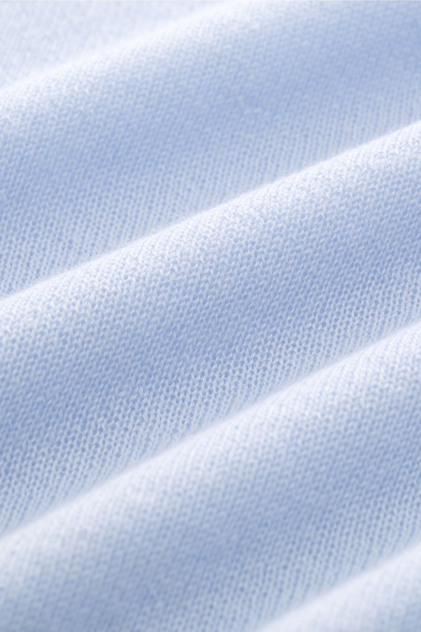 Close-up front view of B.F. Knitwear Cashmere crew neck jumper light blue showing fine, airy knit fabric texture. Lightweight summer cashmere from knitwear experts B.F. KNITWEAR: enhance your spring wardrobe with a durable, Italian-made must-have with thi