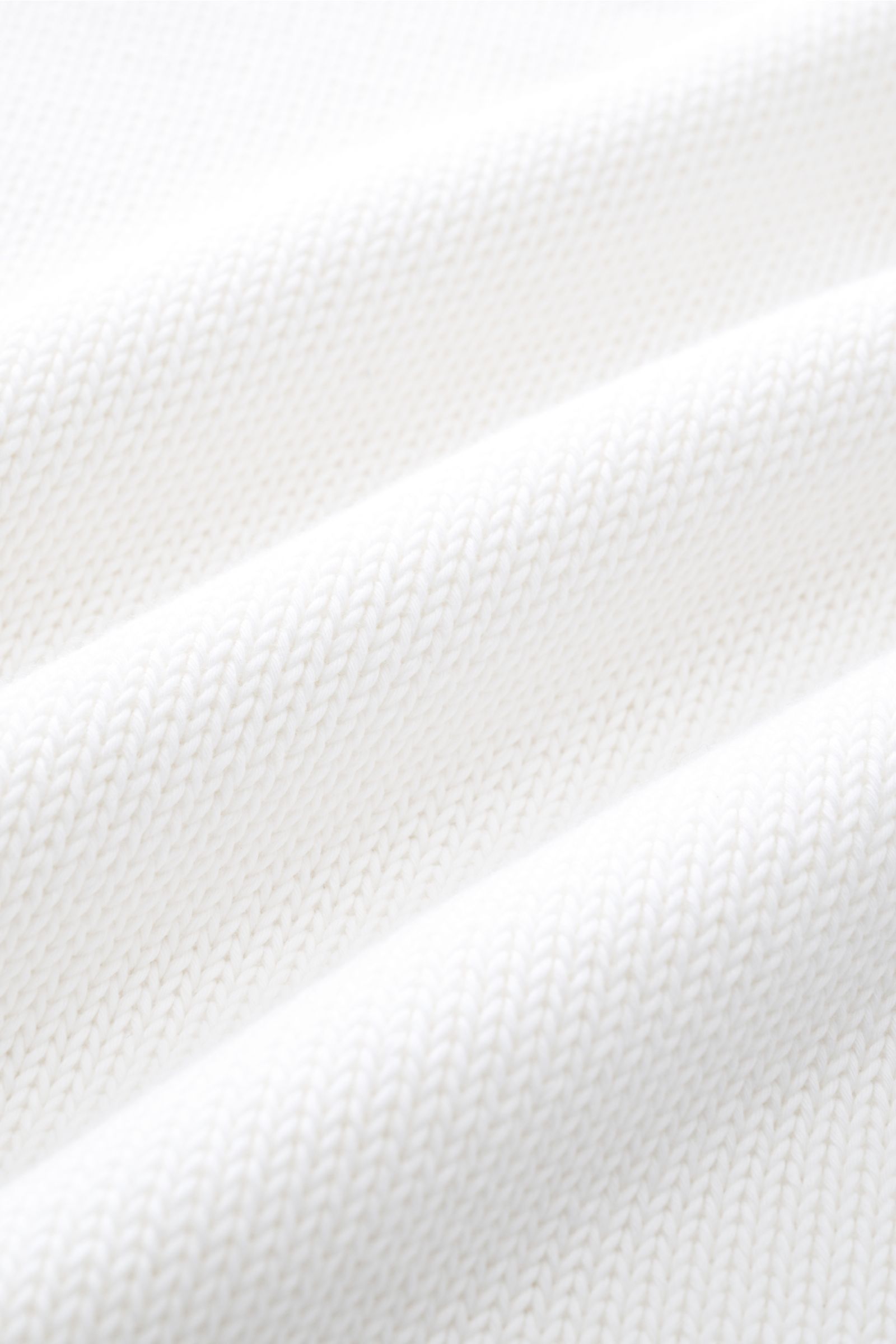 Close-up front perspective of the white Della Ciana Crew neck jumper showing its medium-fine pure Pima cotton knit texture.

This elegant Italian cotton jumper by DELLA CIANA will enhance your spring wardrobe with its classic fit and can be styled in a