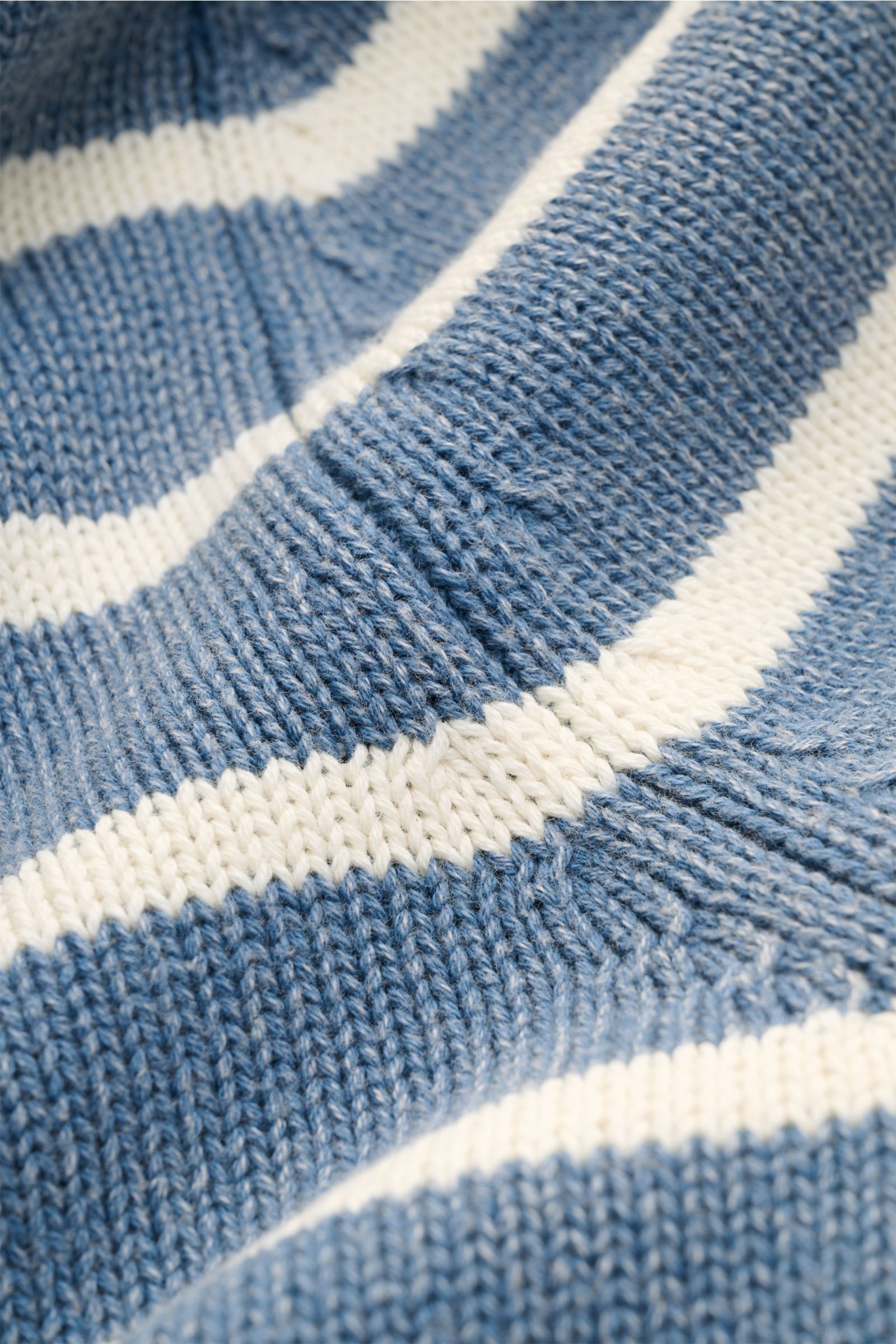 Close-up front view of the MC2 Saint Barth Crew neck jumper 'Sydney Cotton' smoky blue/cream striped, showing soft pure cotton knit, classic stripes, and ribbed texture. Dancing barefoot on a table: The 'Sydney Cotton' crew neck jumper from MC2 Saint Bart